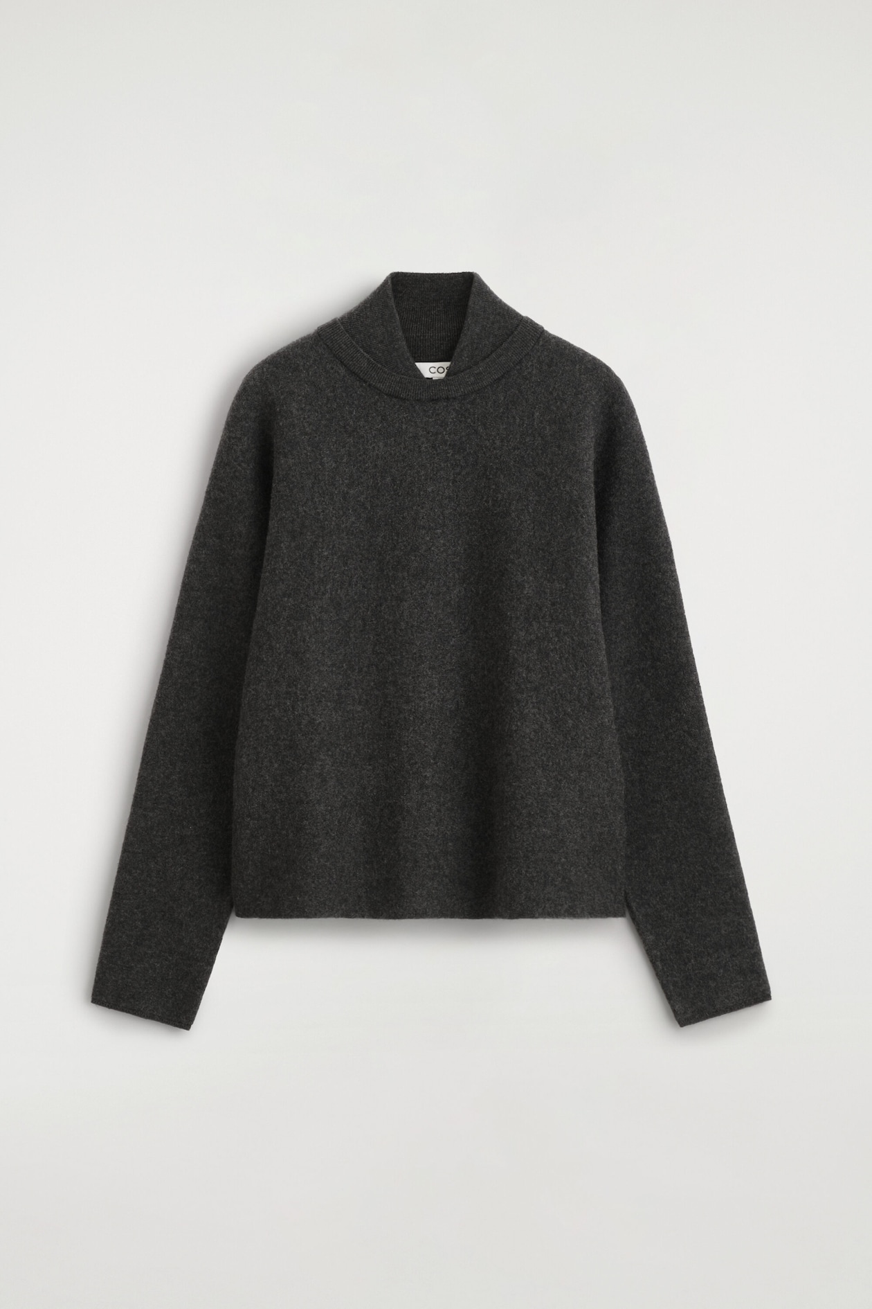 The layered-collar boiled-wool sweater is shown from the front, featuring a relaxed, boxy silhouette in a dark charcoal gray hue. It has a distinctive double-layered neckline with a ribbed inner mock neck, long sleeves, and clean-cut edges at the cuffs and hem.