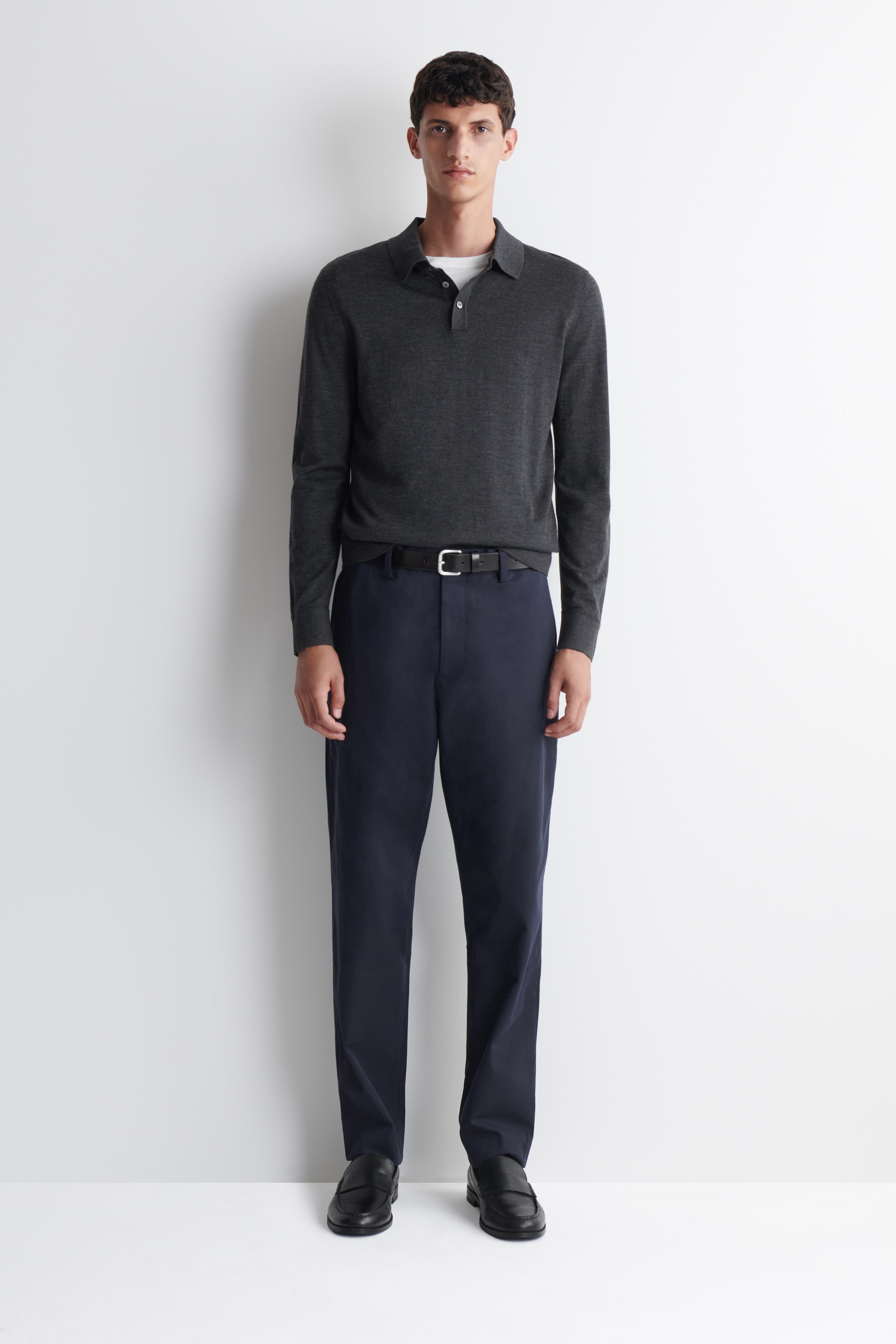 I pantaloni blu scuro sono mostrati in una vista frontale. Hanno una vestibilità slim a gamba dritta e presentano tasche laterali oblique e passanti per la cintura in vita.
