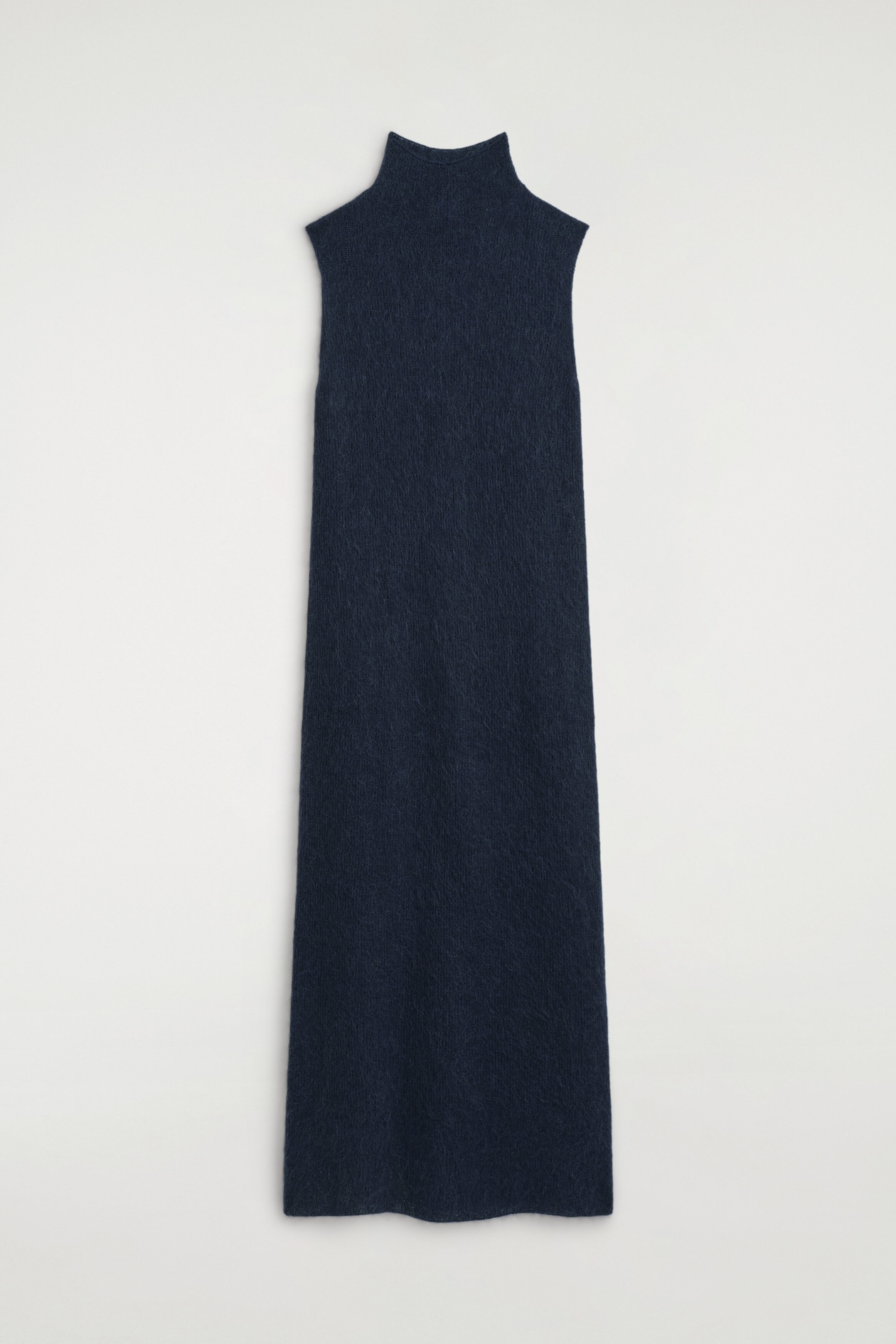 The brushed funnel-neck dress is shown from the front in a sleeveless, column-style silhouette in dark navy blue knit. It features a high, structured funnel neck and a soft, fuzzy brushed texture throughout its long, straight-cut design.