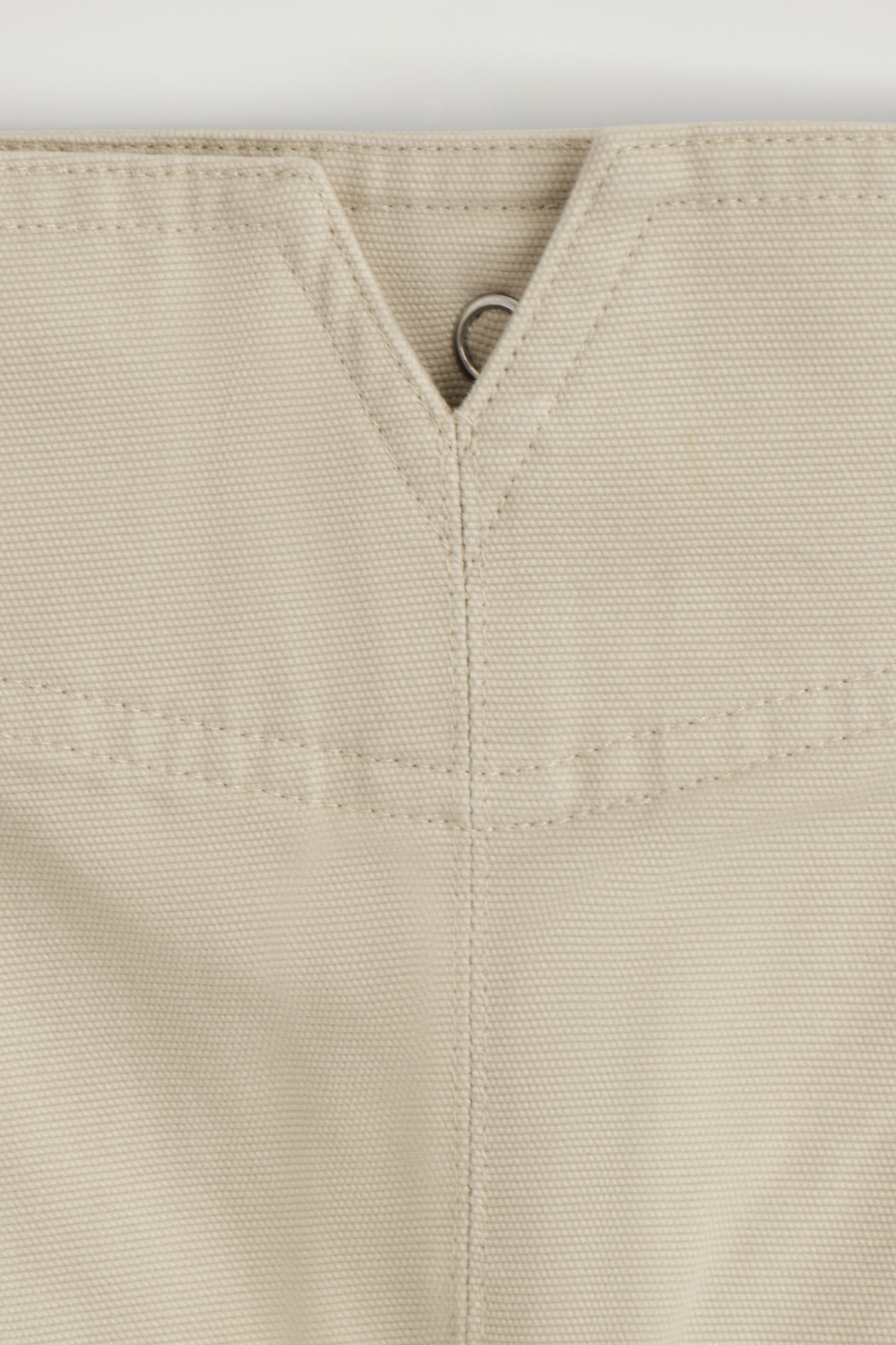 PLEATED BUCKLE-DETAIL MINI SKIRT — LIGHT BEIGE
