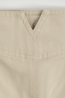 PLEATED BUCKLE-DETAIL MINI SKIRT — LIGHT BEIGE 2