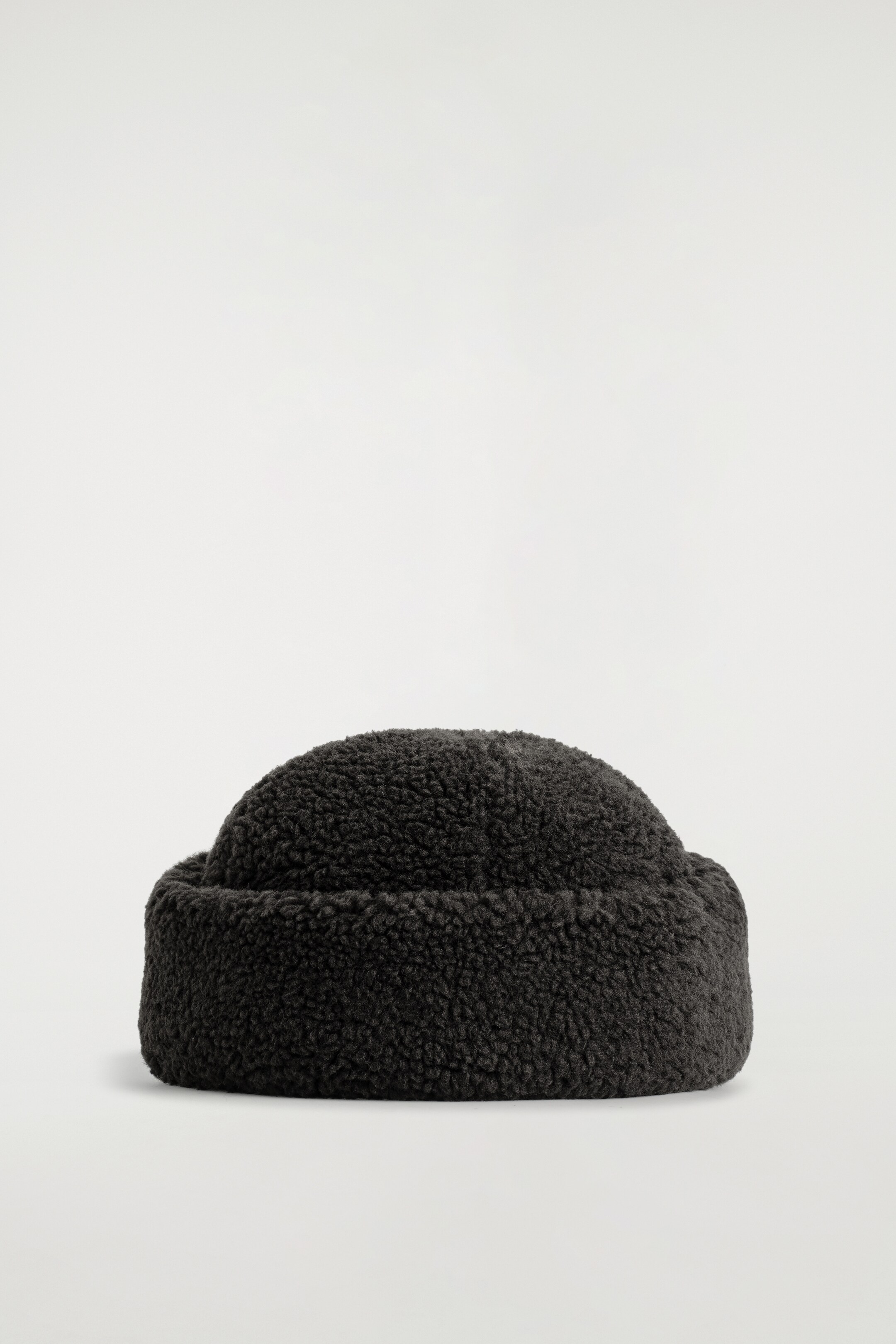 View larger image: A dark gray shaggy fleece hat is presenting a front view, featuring a rounded crown and a wide, upturned brim.
