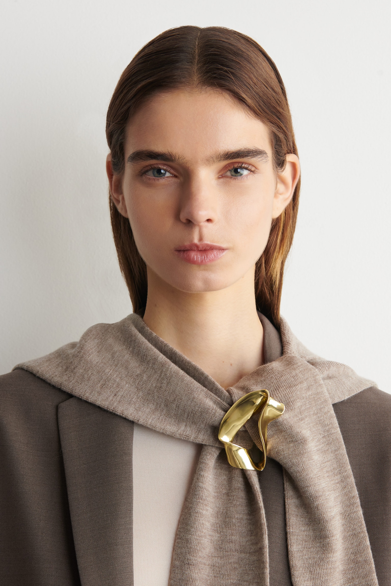 twisted ribbon pin brooch by cos with a sculptural finish