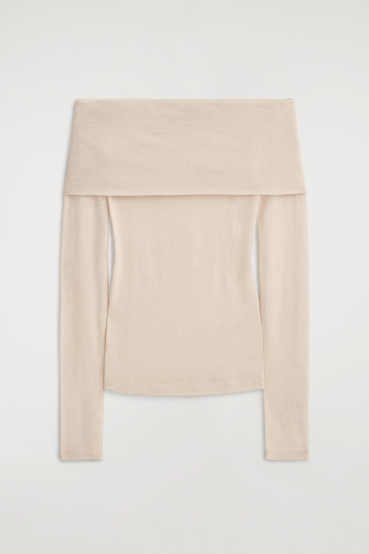 An off-the-shoulder merino wool top is shown from the front, featuring a wide, folded-over neckline that extends over the upper arms. The light beige, fine-knit garment has long sleeves and a fitted bodice with a straight hem.