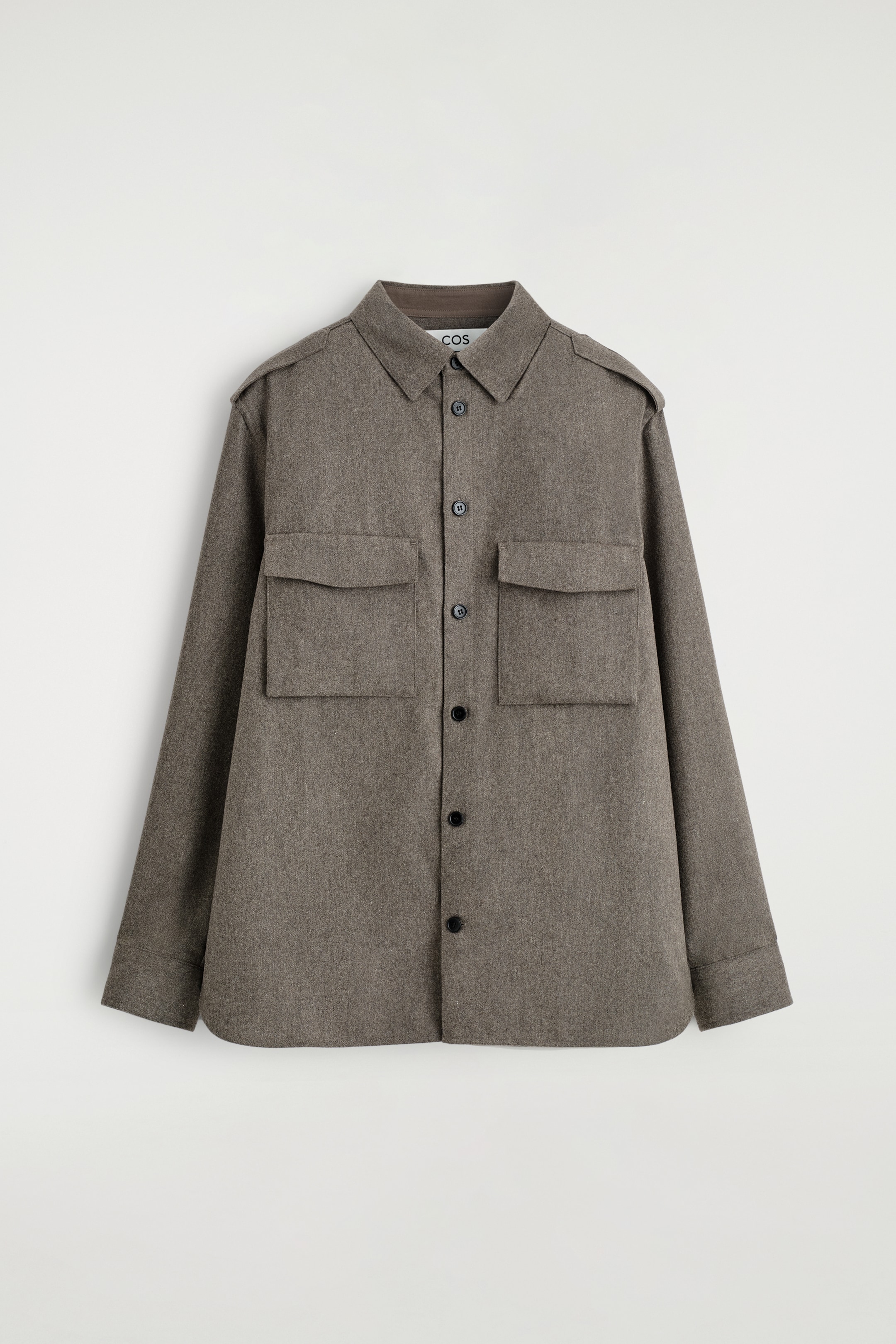 View larger image: A heathered grey-brown utility shirt is being shown from the front, presenting a relaxed fit. It is crafted from a textured, wool-like fabric and is featuring a classic collar, a button-down front with black buttons, two large flap patch pockets on the chest, and epaulettes on the shoulders.