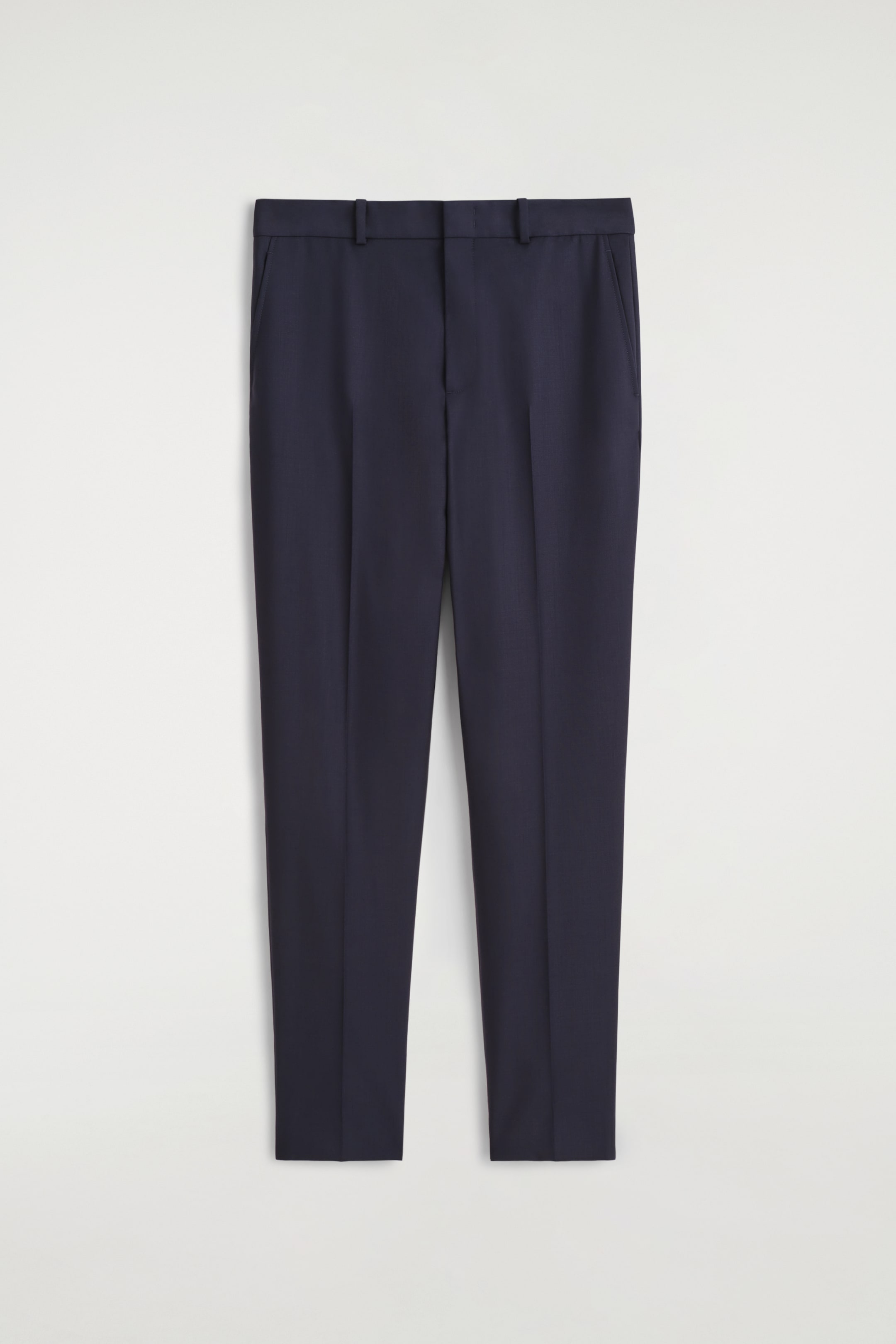 View larger image: Dark blue straight-leg trousers are displaying front-facing, featuring a clean waistband with belt loops. Pressed creases are running down the front of each leg, and discreet welt pockets are visible at the hips.