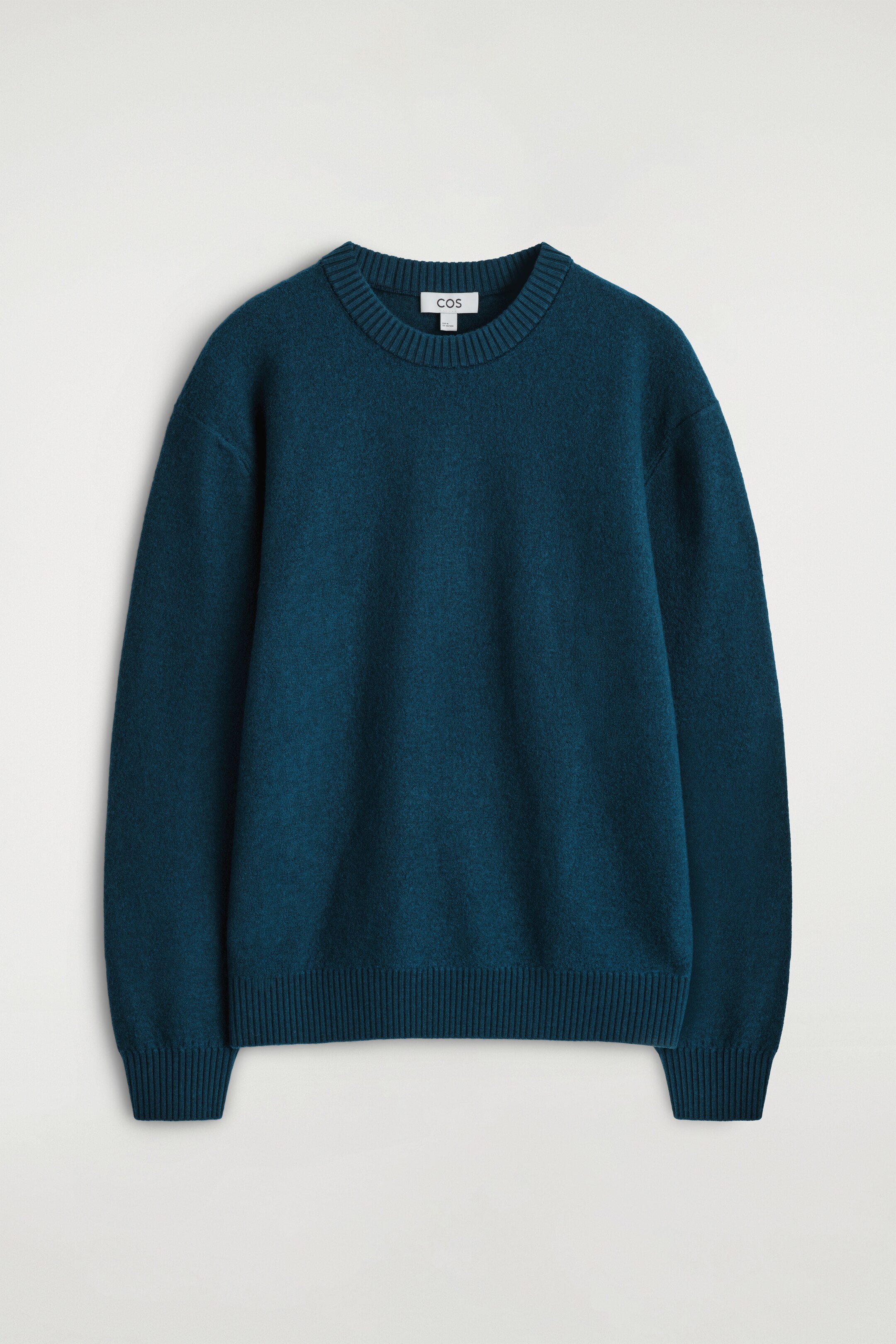 View larger image: A teal knit sweater is presented facing front, featuring a crew neck and ribbed trims on the collar, hem, and cuffs.