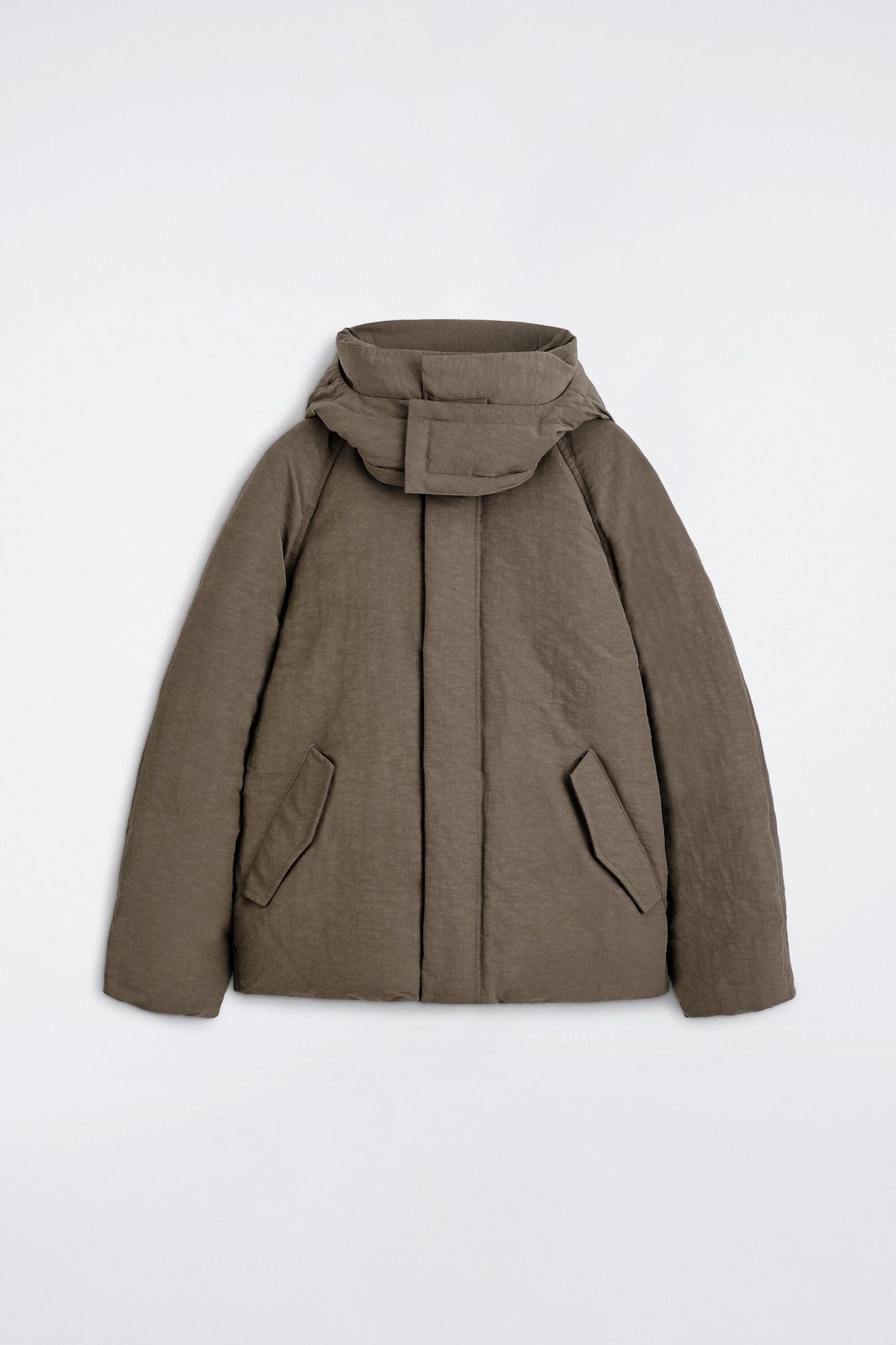 A brown puffer jacket is shown from the front, featuring a textured finish, a high collar with an integrated hood, and a wide chin guard. The design includes a concealed front closure and two angled welt pockets with flaps.