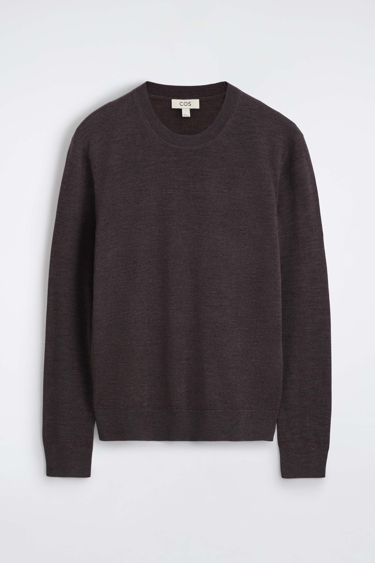 The slim merino wool crew-neck sweater is shown from the front, highlighting its fine-knit texture in a dark brown mélange color. It features a classic ribbed crew neck, long sleeves with ribbed cuffs, and a ribbed hem.