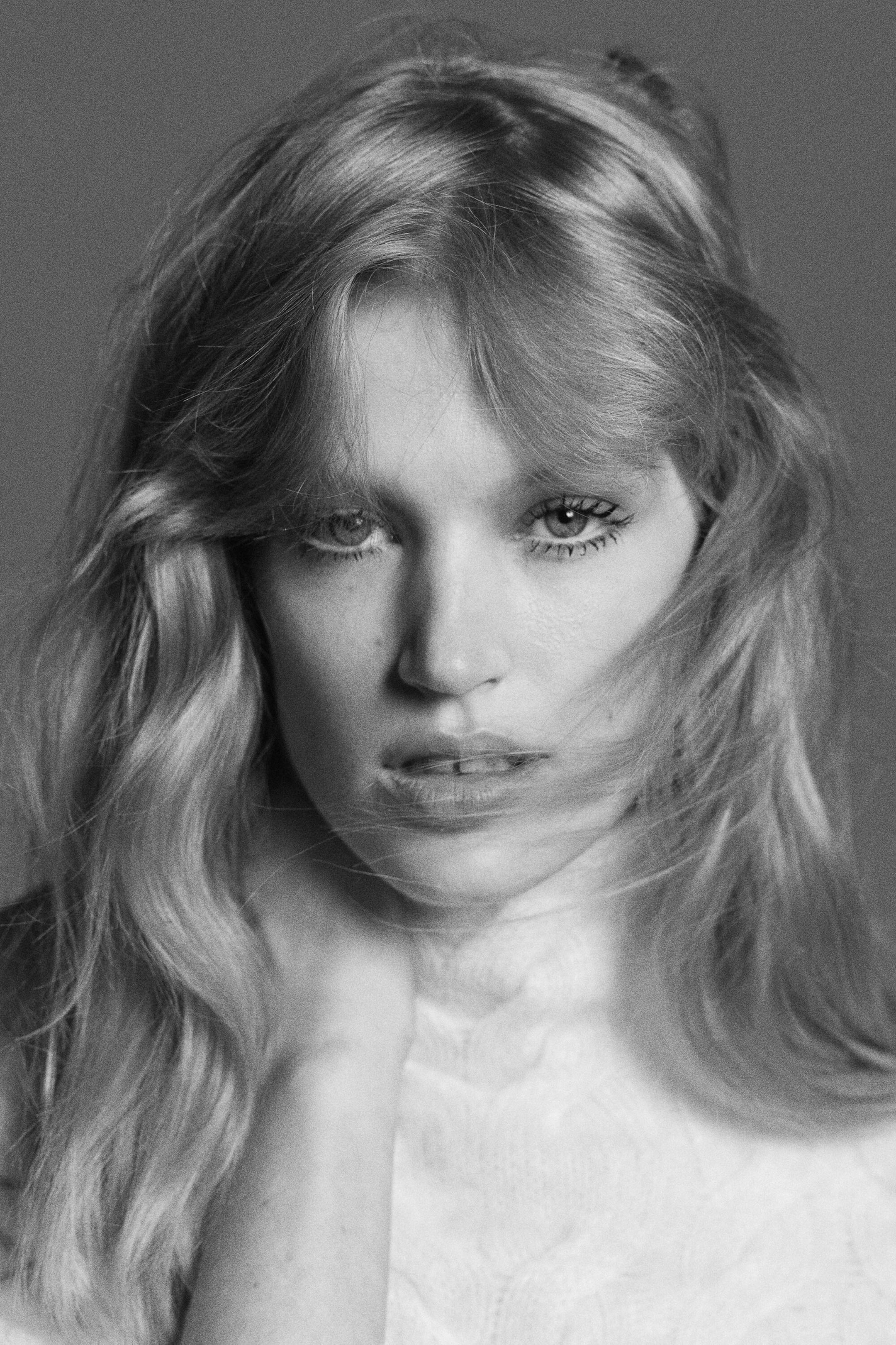The cable-knit brushed cashmere funnel-neck sweater is shown in a close-up, front-facing view, highlighting its high funnel neck and textured, soft cable-knit pattern. The cable-knit brushed cashmere funnel-neck sweater is shown in a close-up, front-facing view, highlighting its high funnel neck and textured, soft cable-knit pattern.
