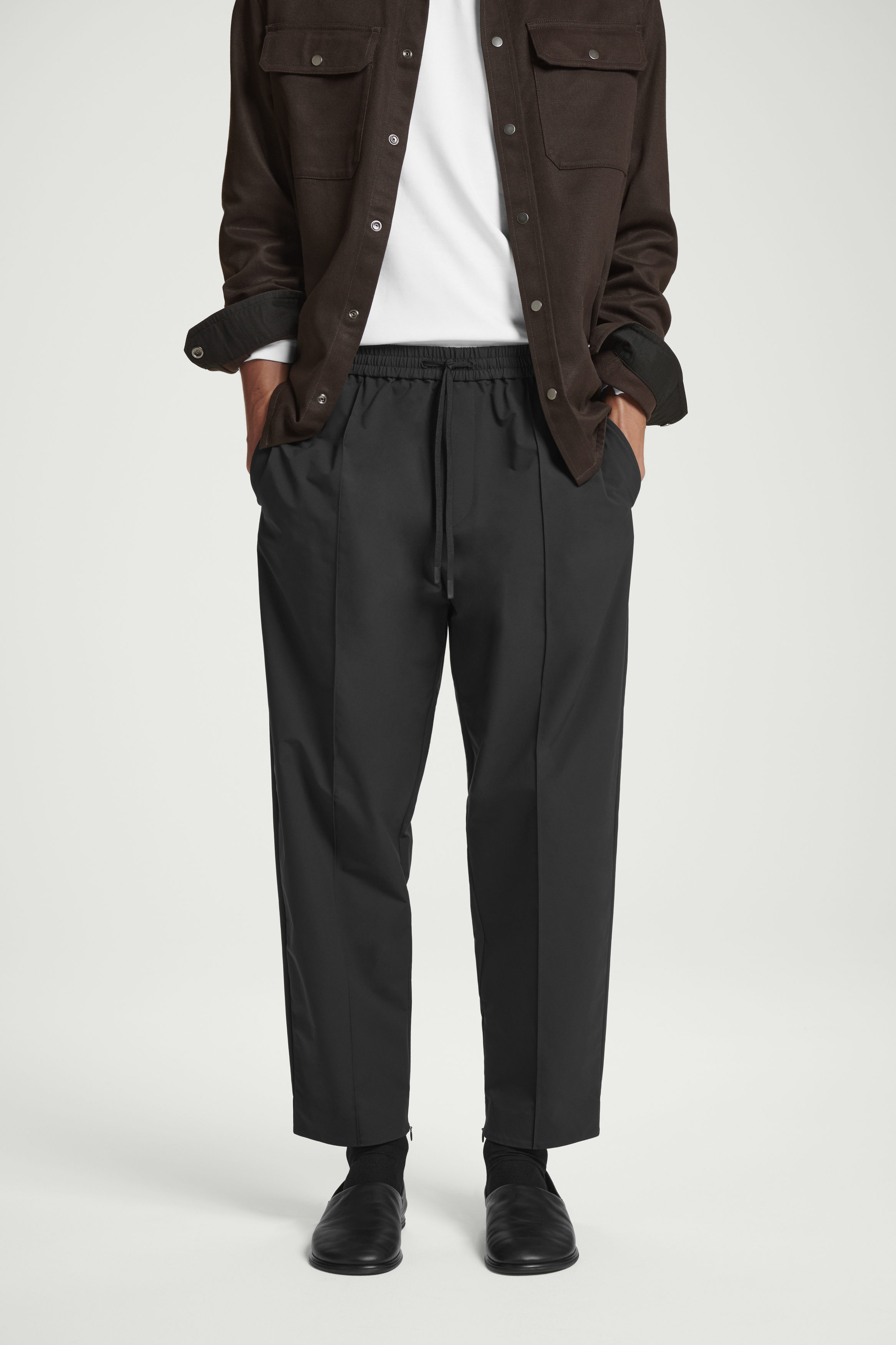 PINTUCKED TAPERED TRACK PANTS - BLACK | COS