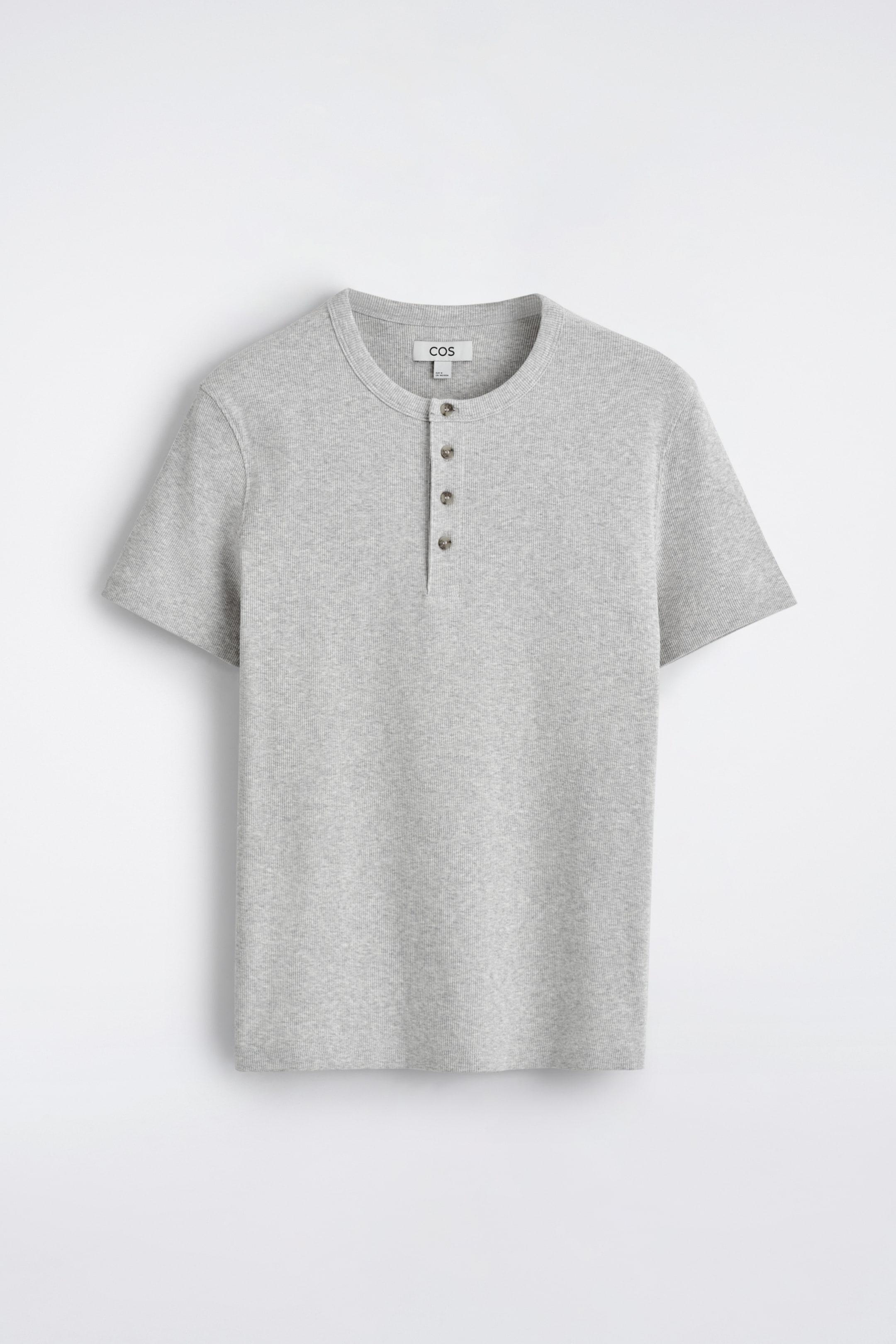 View larger image: A light grey, finely ribbed Henley T-shirt is being displayed from the FRONT. It is showcasing a round neckline, a four-button placket with dark buttons, and short sleeves.