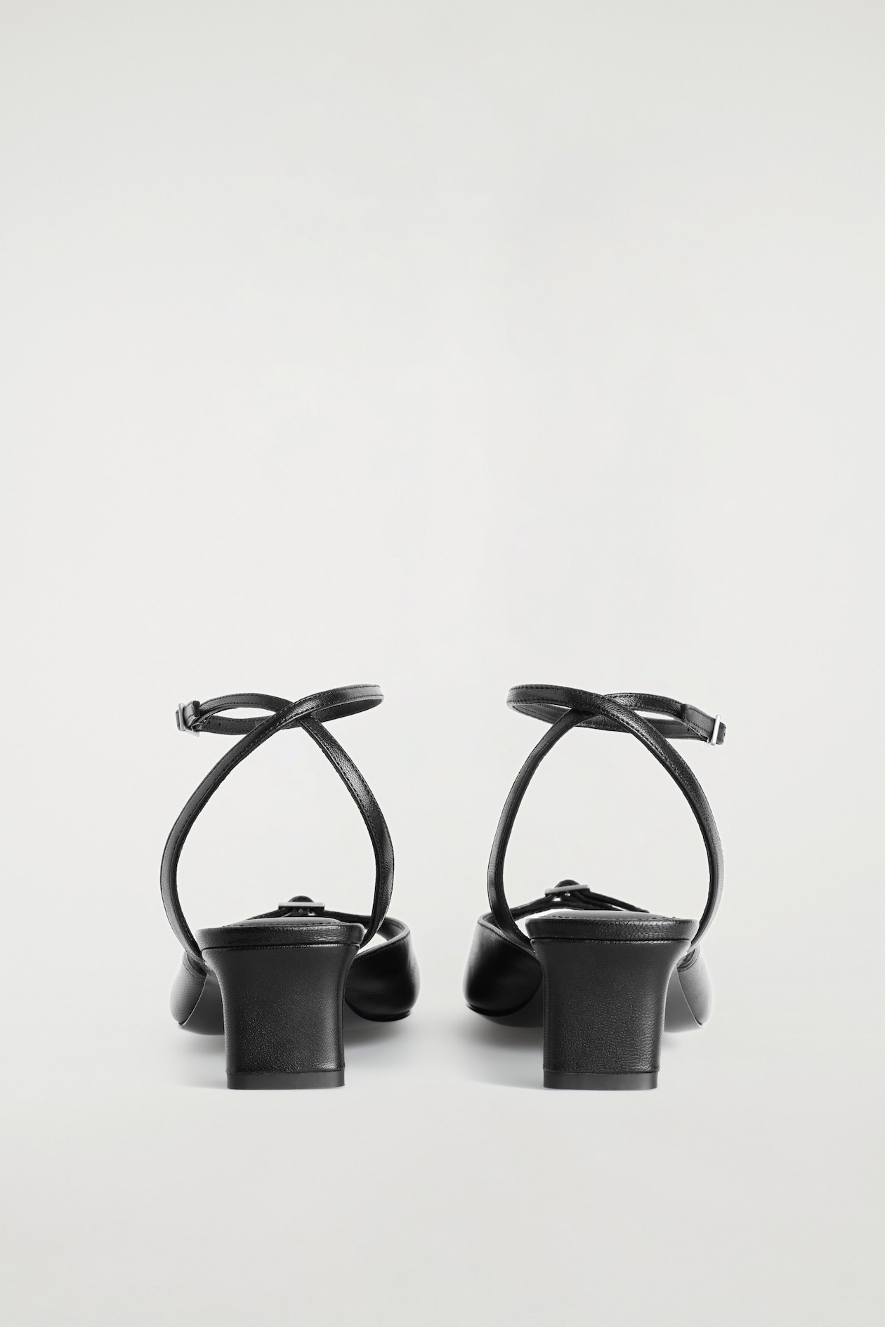 BUCKLED LEATHER KITTEN HEELS — BLACK