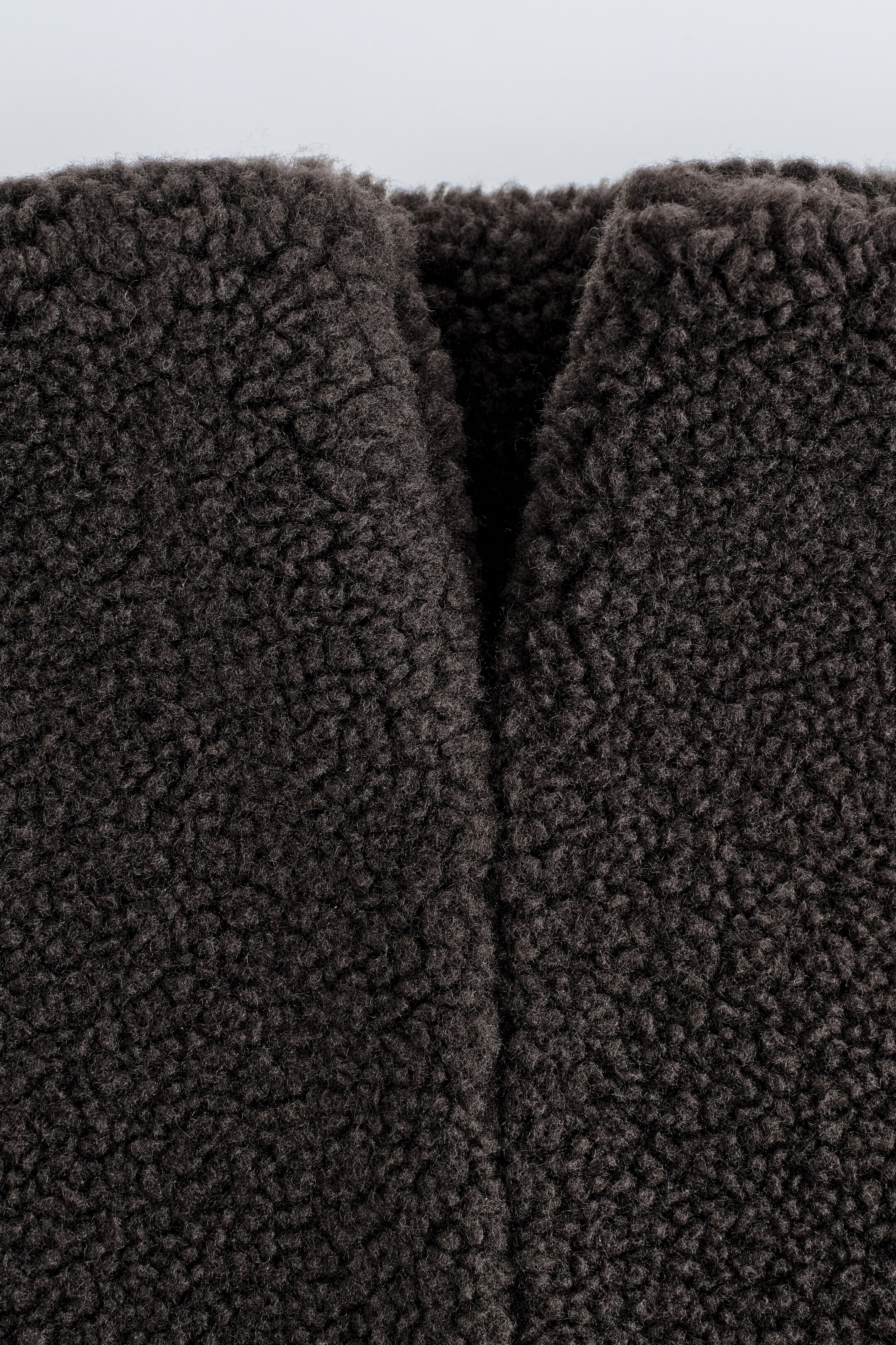 View larger image: The dark-chocolate snood is being shown, featuring deeply textured, plush teddy fabric with a prominent central V-shaped fold.