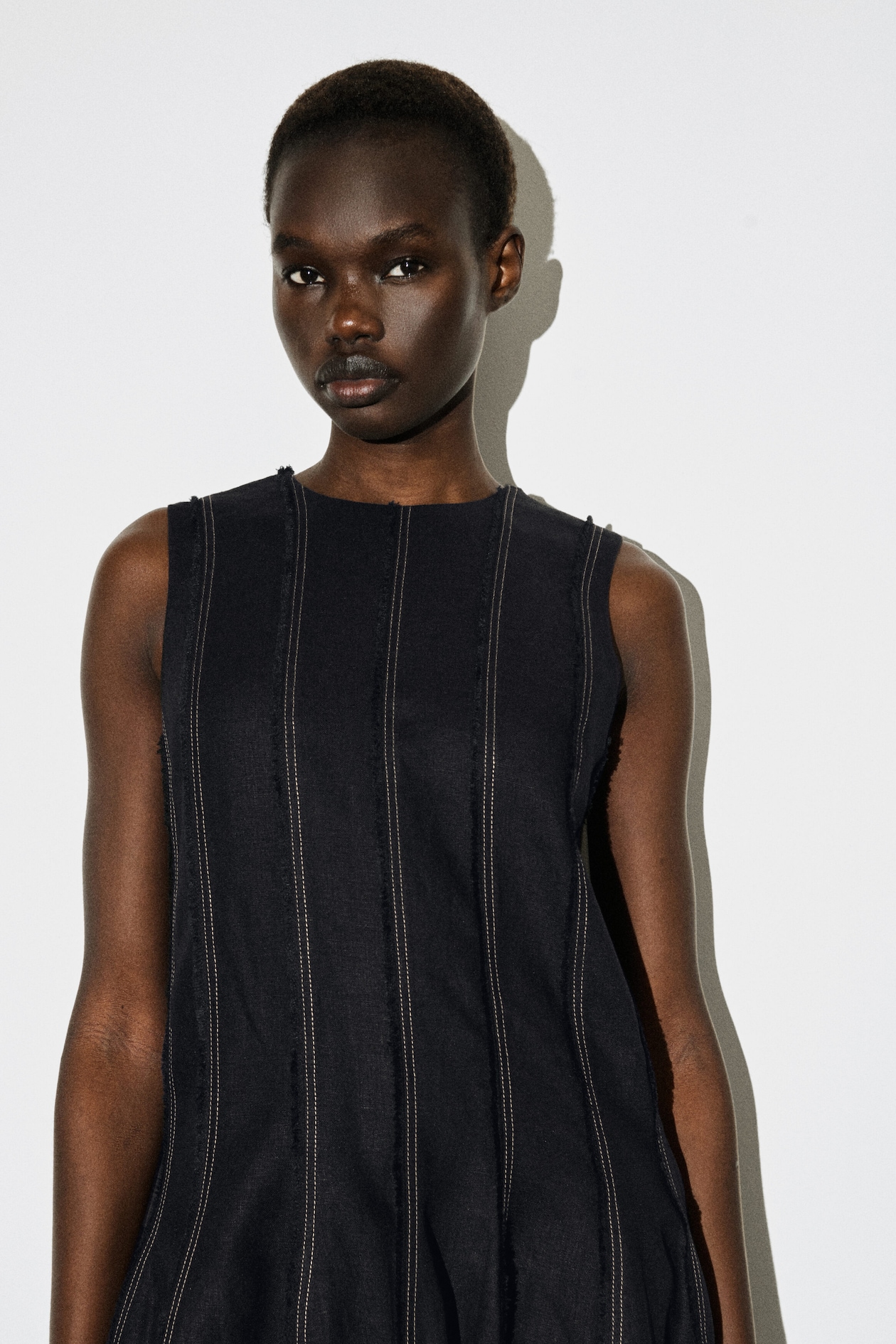 SCULPTED PLEATED MINI DRESS — BLACK