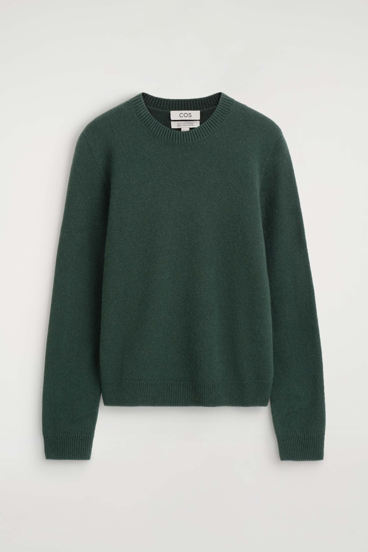 A dark green cashmere crewneck sweater is shown from the front, featuring a ribbed crew neckline, long sleeves with ribbed cuffs, and a ribbed hem.