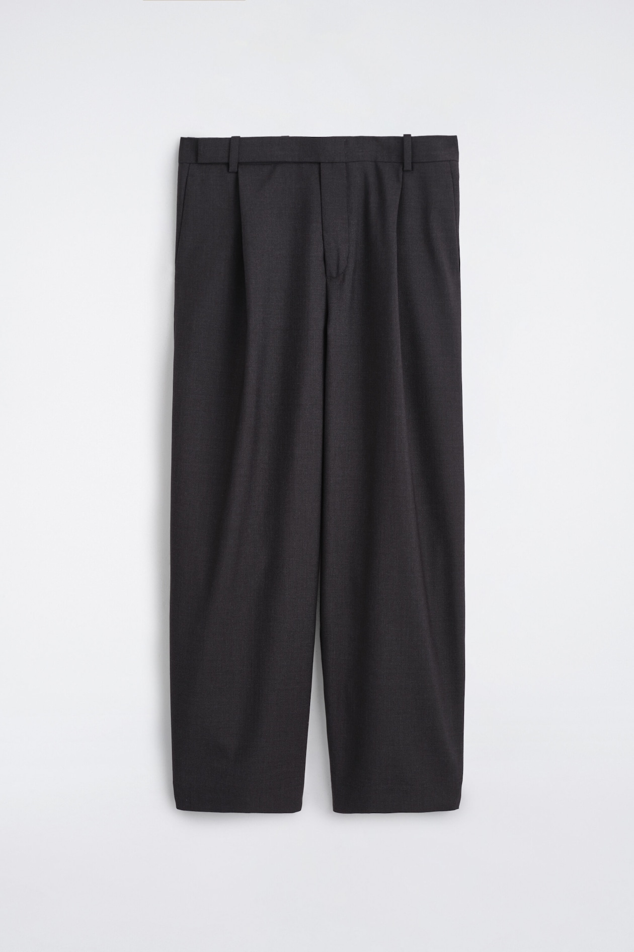 These wool relaxed-fit barrel-leg trousers are shown from the front, displaying a dark charcoal grey colour and a structured, voluminous silhouette. The trousers feature a waistband with belt loops, subtle front pleats, and a concealed fastening flowing into a tapered barrel-leg shape.