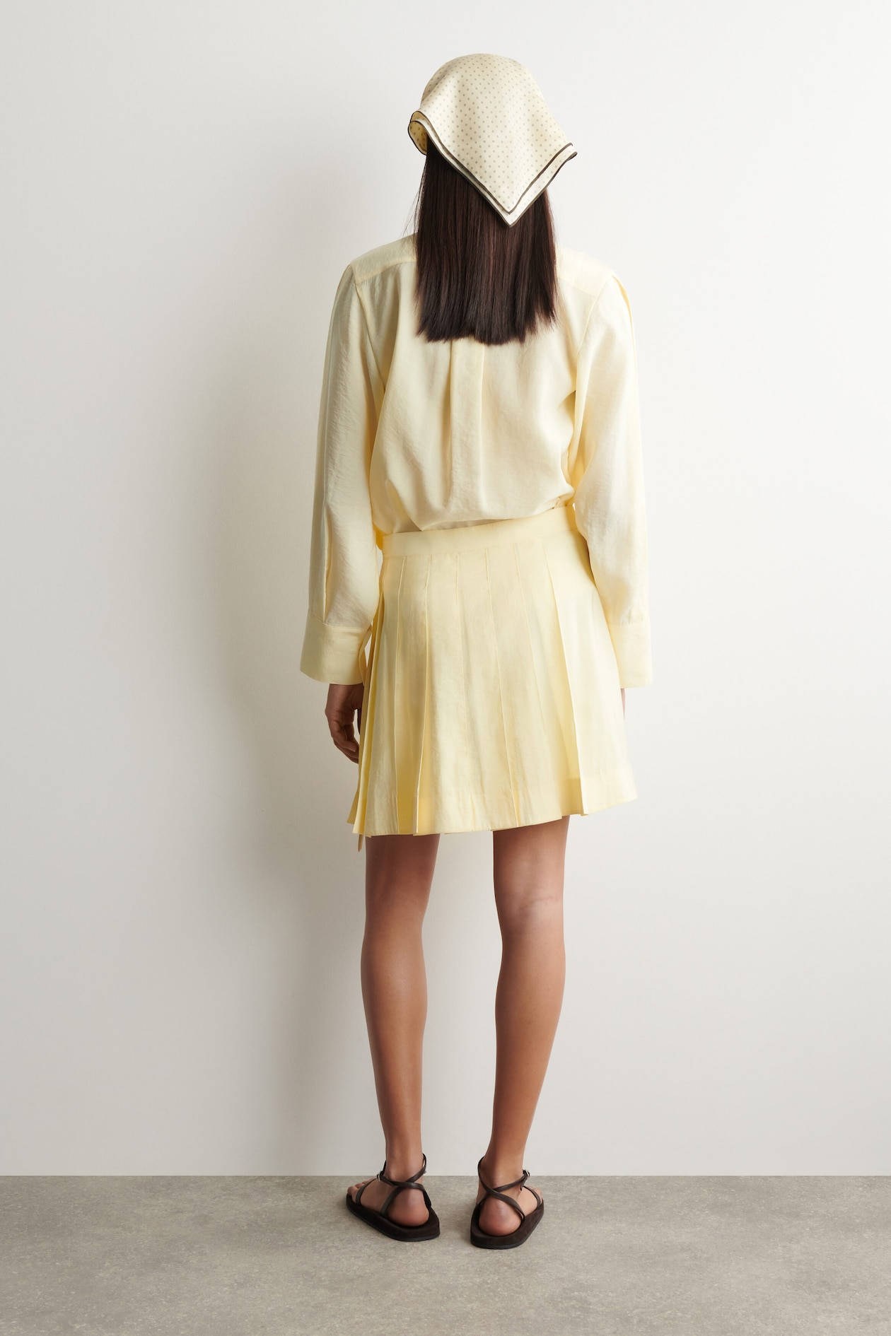 PLEATED MINI WRAP SKIRT — BUTTER YELLOW