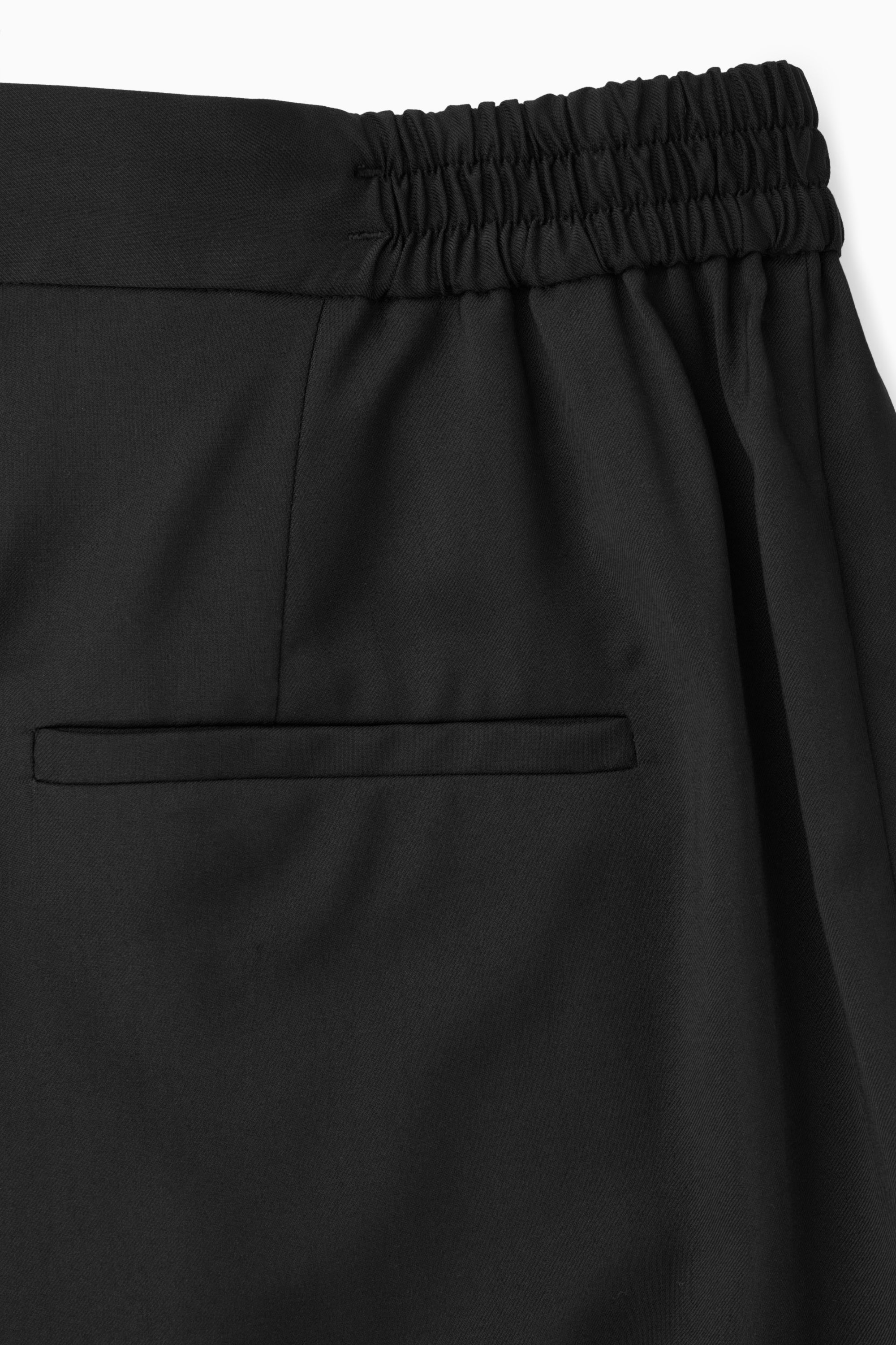 TAPERED ELASTICATED WOOL TROUSERS - BLACK | COS