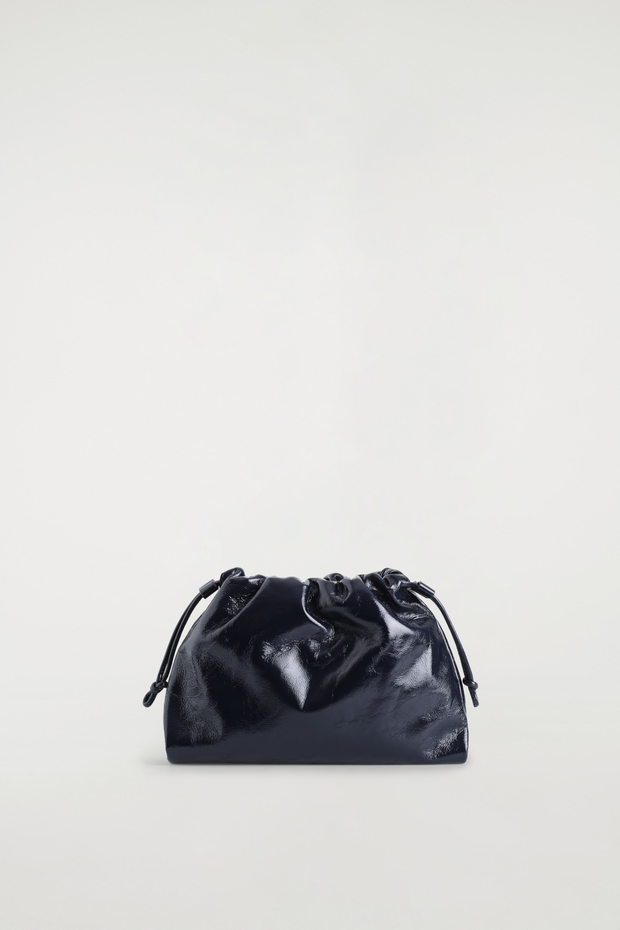 Visualizza immagine più grande: Una pochette scura e riflettente è presentata frontalmente, caratterizzata da un profilo morbido e arricciato con cordoncini annodati che stringono la parte superiore su entrambi i lati.
