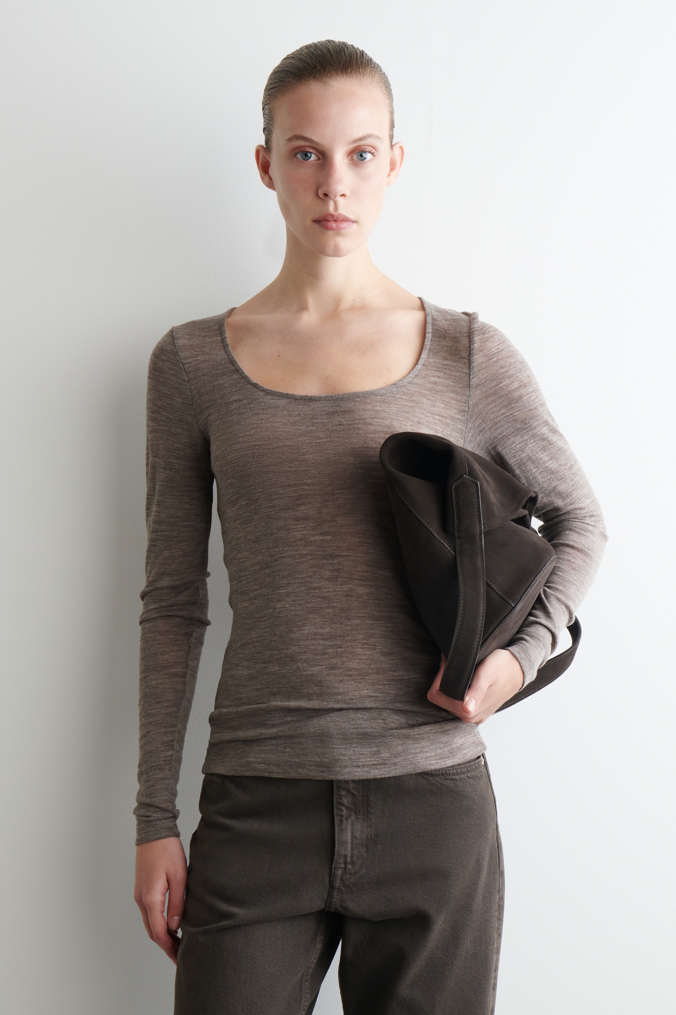 View larger image: A heathered brown, fine-knit long-sleeved top is being worn, featuring a wide scoop neck and a fitted silhouette. Its straight hem is resting at the hips, over dark brown pants.
