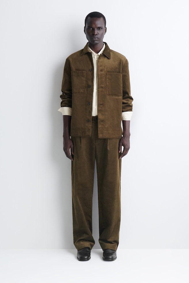 PLEATED RELAXED-FIT TAPERED CORDUROY PANTS — BROWN