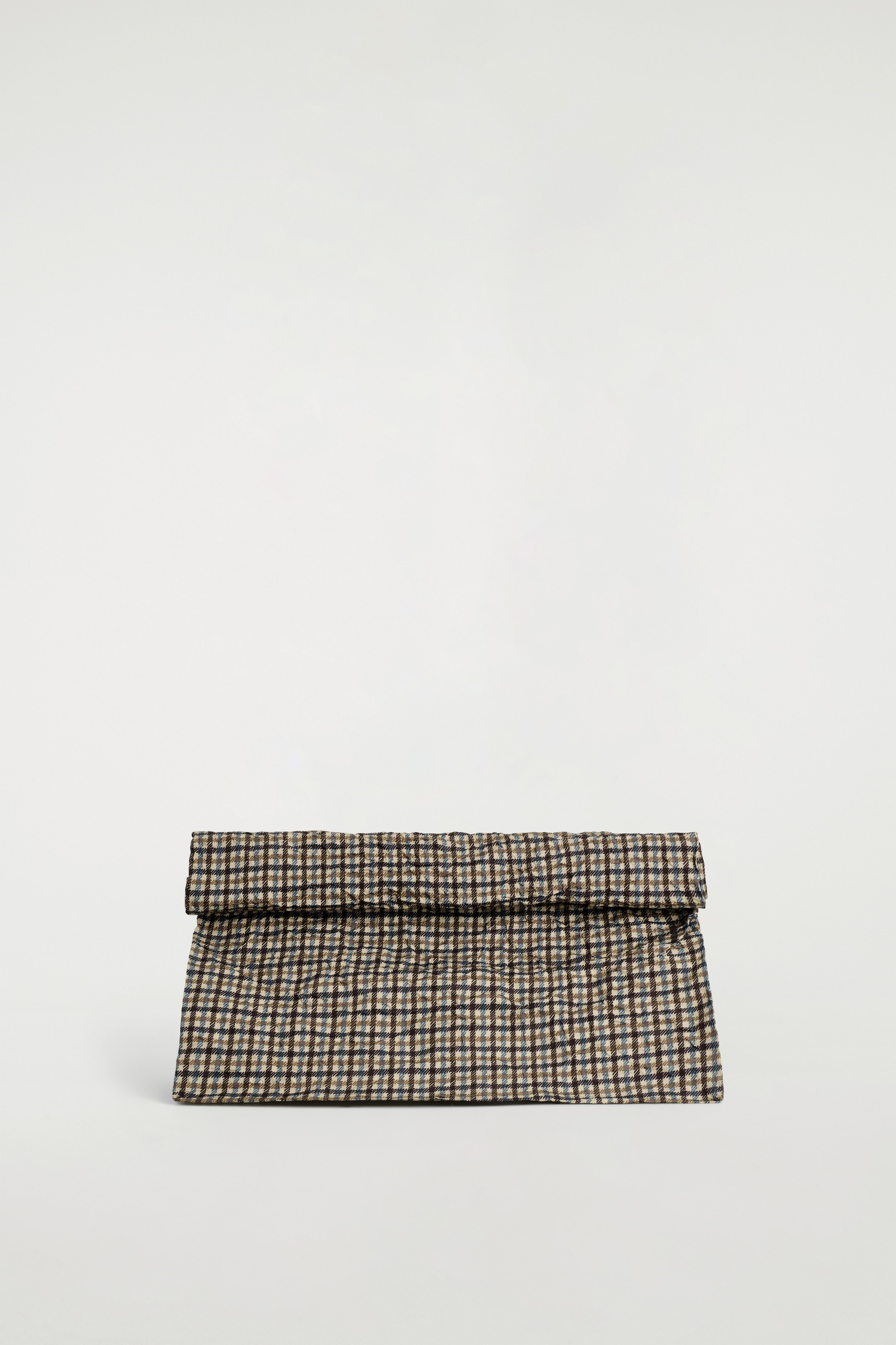 View larger image: A front view of a rectangular pouch is displaying a brown, black, and beige plaid pattern. Its top edge is currently folded over, forming a soft, roll-top closure.