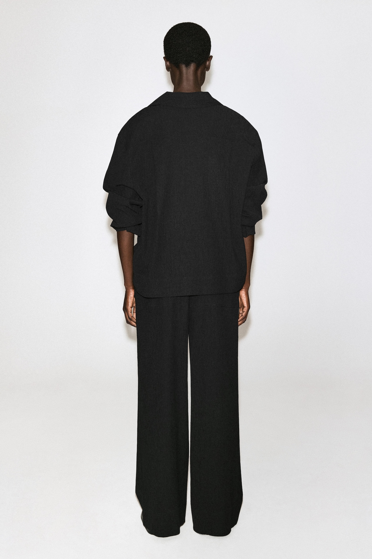 CRINKLED-JERSEY WIDE-LEG TROUSERS — BLACK