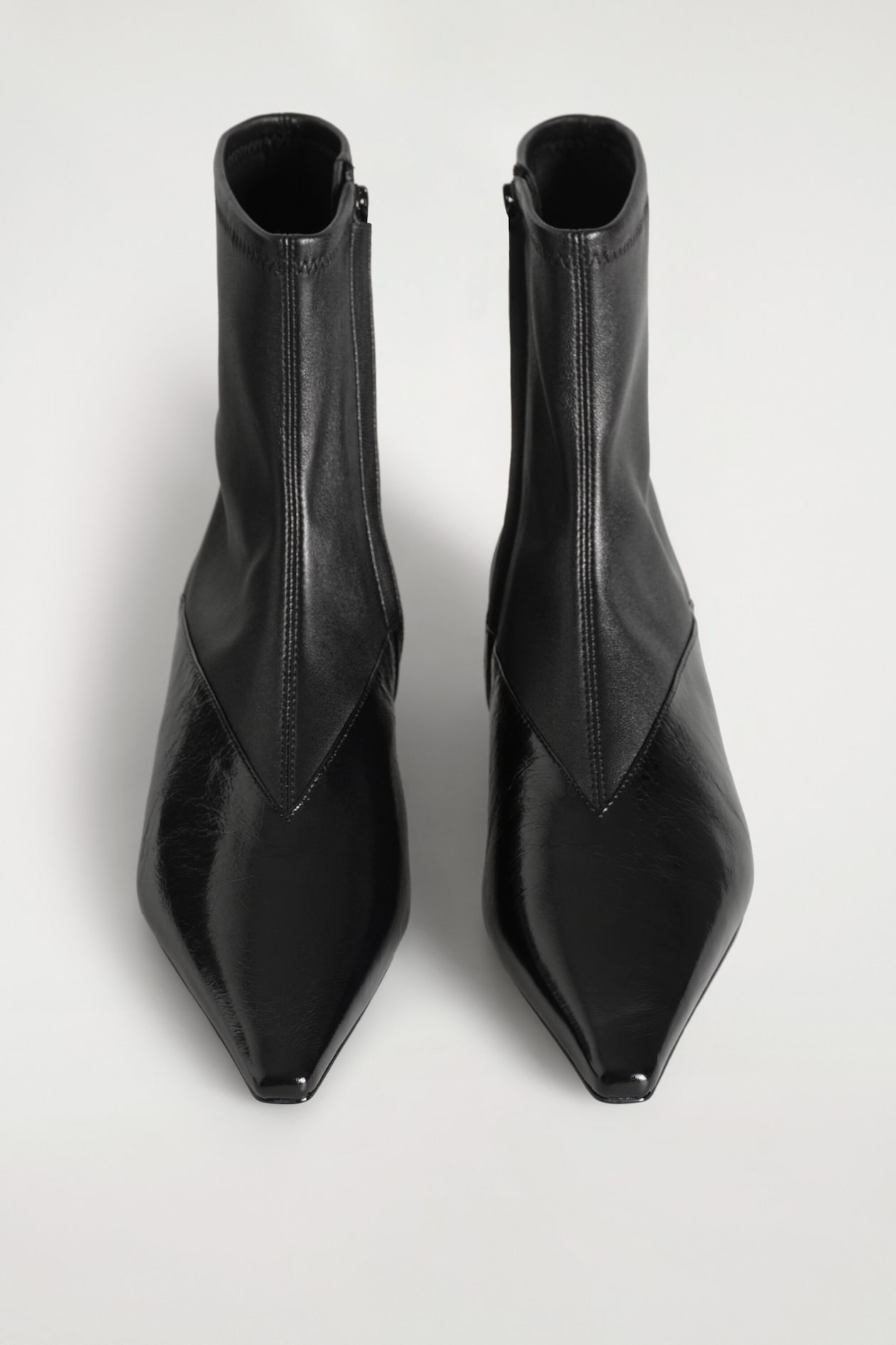 PANELED POINTED LEATHER WEDGE ANKLE BOOTS — BLACK