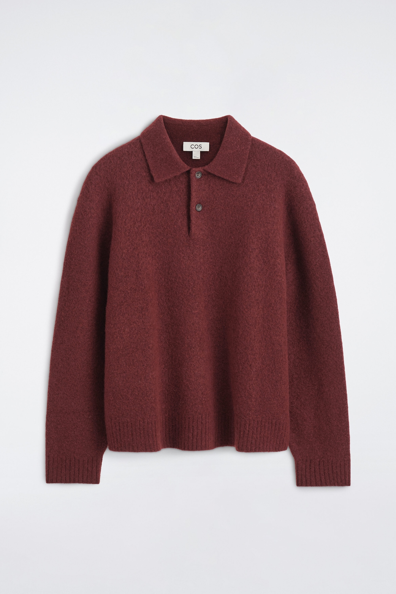 The brushed-wool polo shirt is shown from the front, in a deep burgundy color with a textured, fuzzy knit. It features a spread collar with a two-button placket, long sleeves with ribbed cuffs, and a matching ribbed hem.