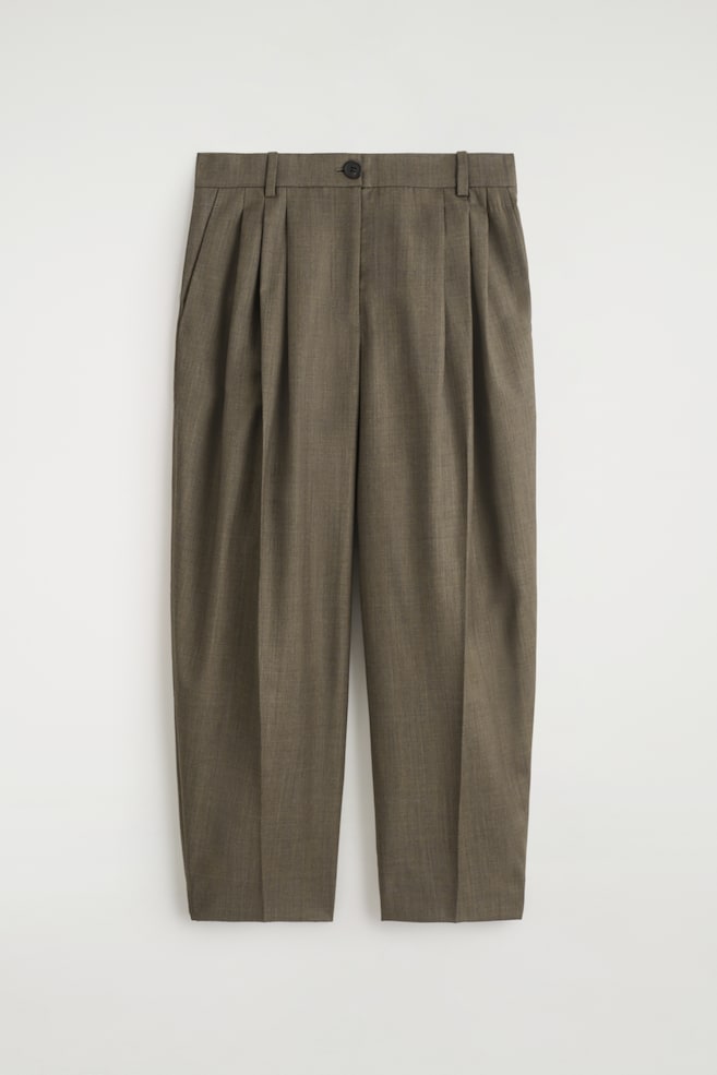 Front view of dark olive-brown trousers, designed with a barrel-leg shape and distinct double pleats on each leg. The trousers are featuring a waistband with belt loops, a visible button closure, slanted side pockets, and are finishing with cropped hems. - 1