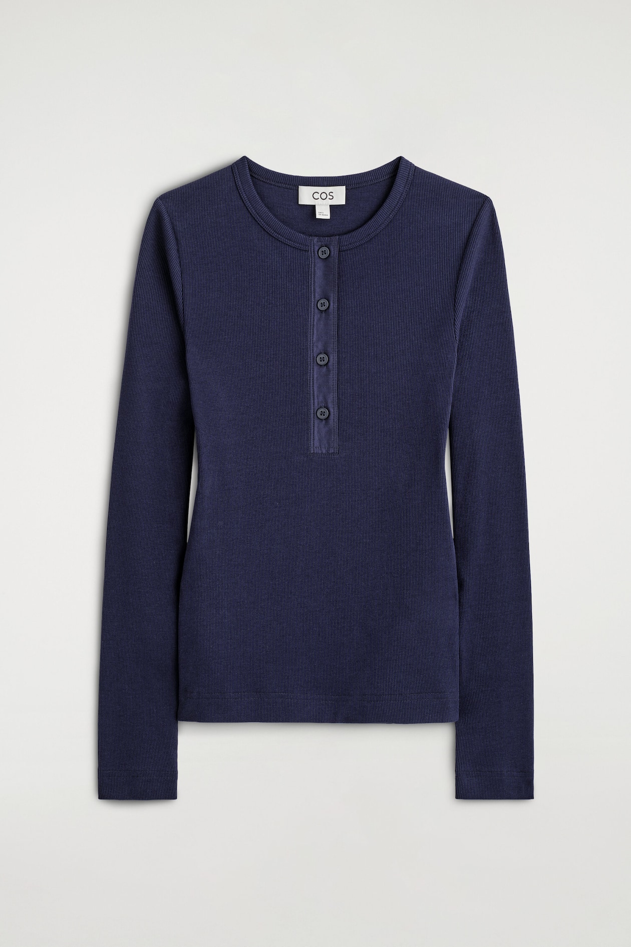 The ribbed cotton henley top is shown from the front, featuring a dark navy blue ribbed knit texture, a crew neckline, and long sleeves. It is detailed with a four-button placket extending down the center front chest.