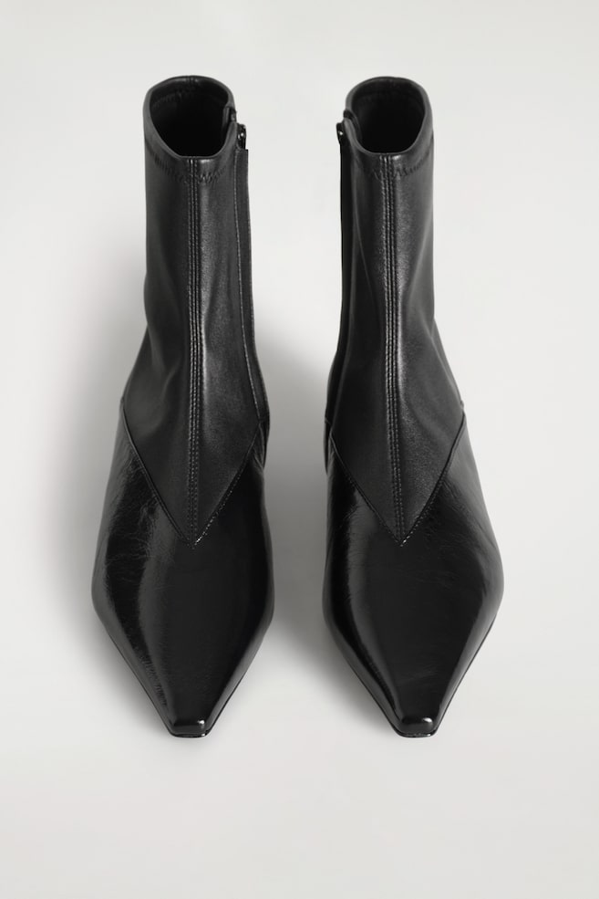 PANELED POINTED LEATHER WEDGE ANKLE BOOTS — BLACK