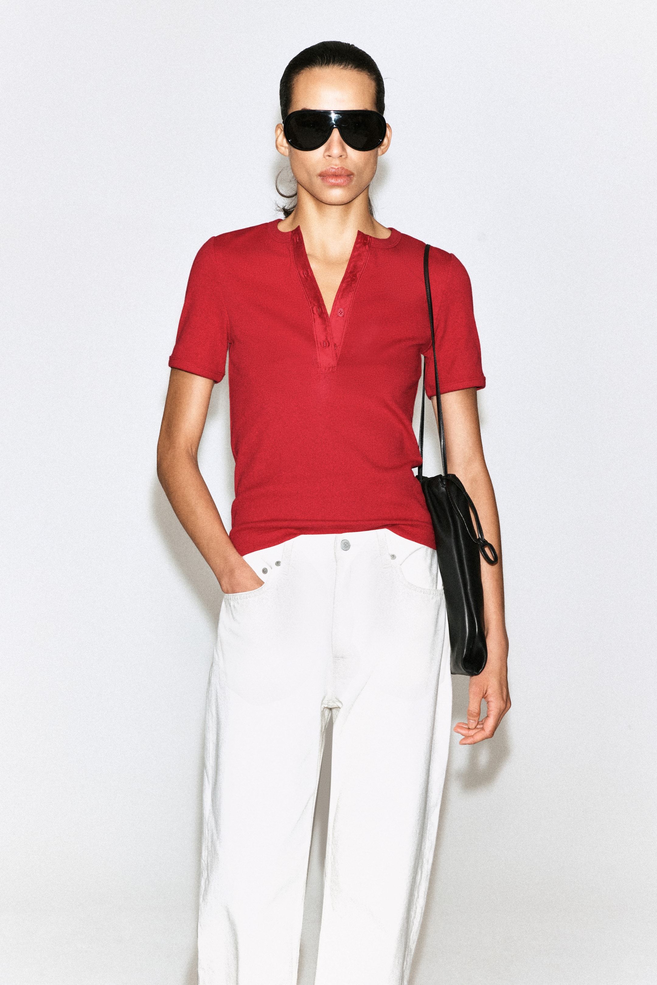 View larger image: A red ribbed Henley T-shirt is displayed from the front, featuring short sleeves and a V-neck placket with three buttons.