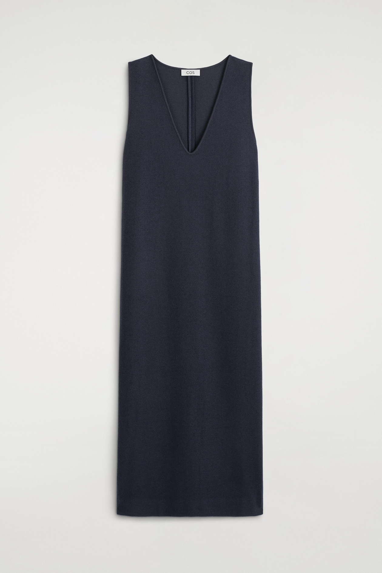 The boiled wool-blend V-neck midi dress in navy blue is displayed from the front, showcasing a deep V-neckline, sleeveless design, and a straight, clean-lined midi silhouette with a textured finish.
