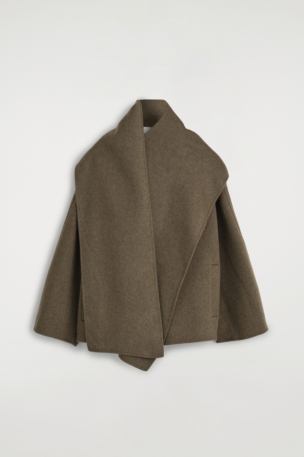 The double-faced wool-blend scarf jacket in a muted brown tone is hanging at a front angle, featuring an integrated scarf draped over the shoulders and front. The relaxed-fit garment showcases wide, flared sleeves and clean-finished edges.