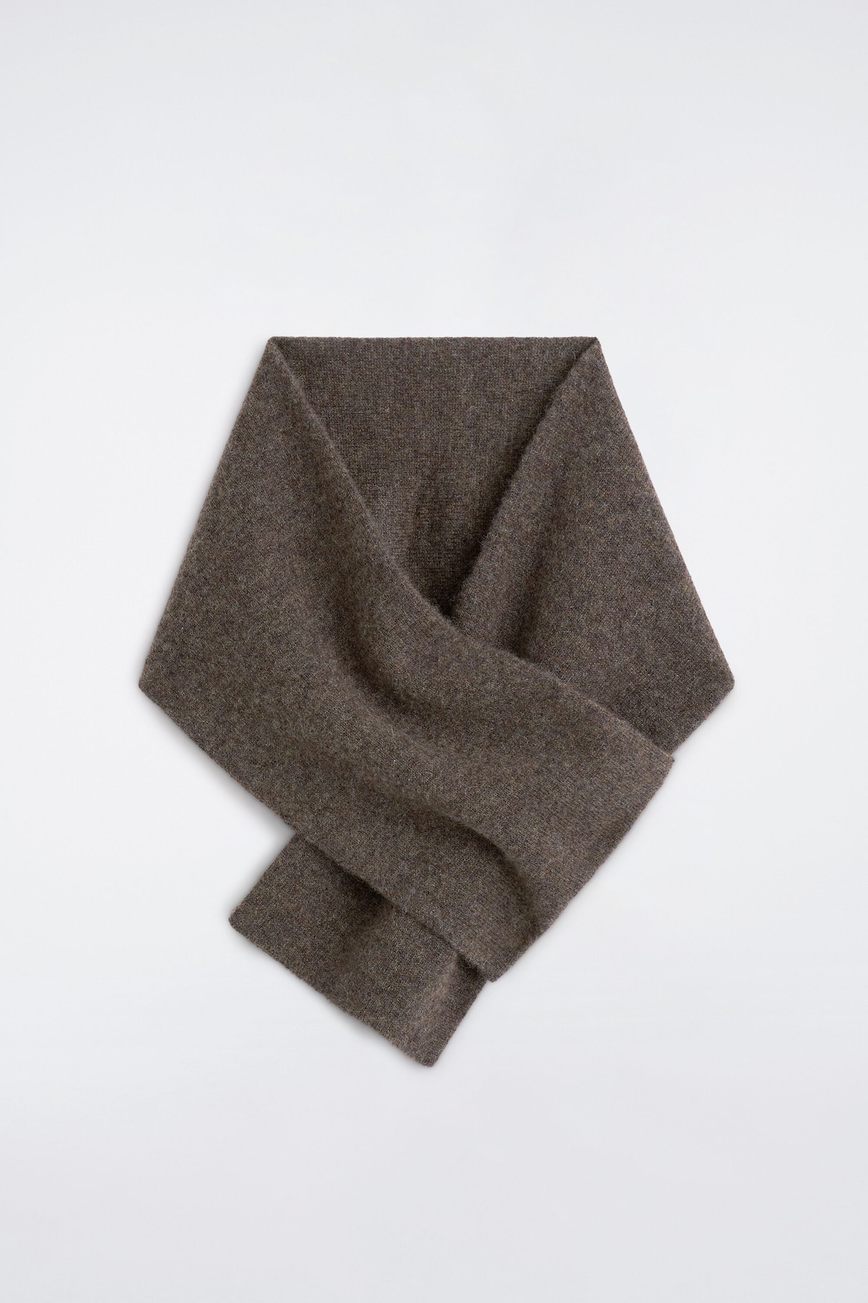A cashmere pull-through scarf in a textured dark brown mélange knit is shown in a flat lay front view. The scarf features a crossed-over design with one end threaded through a slit to form a draped, structured loop.
