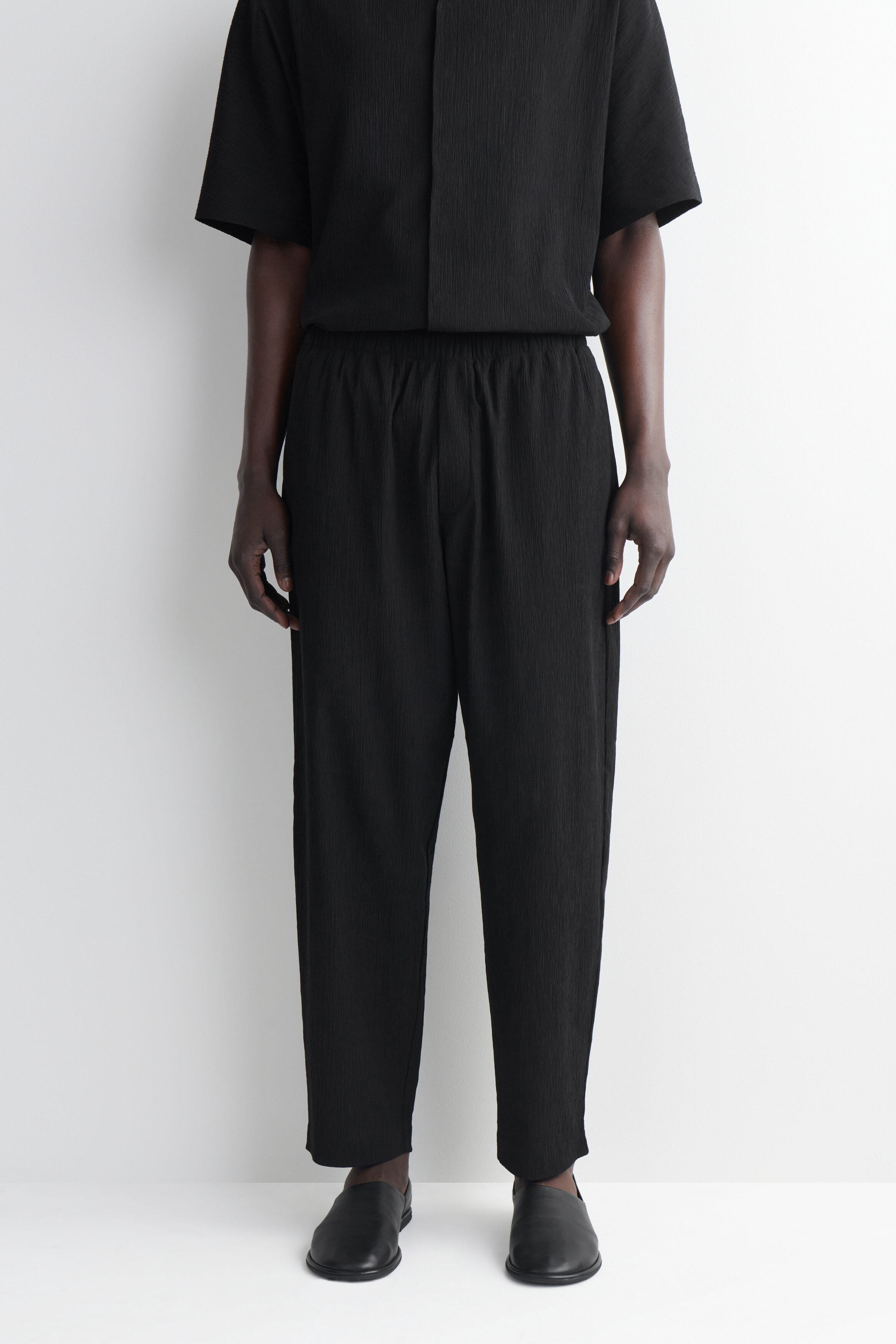 CRINKLED-COTTON RELAXED-FIT TAPERED PANTS - BLACK | COS US