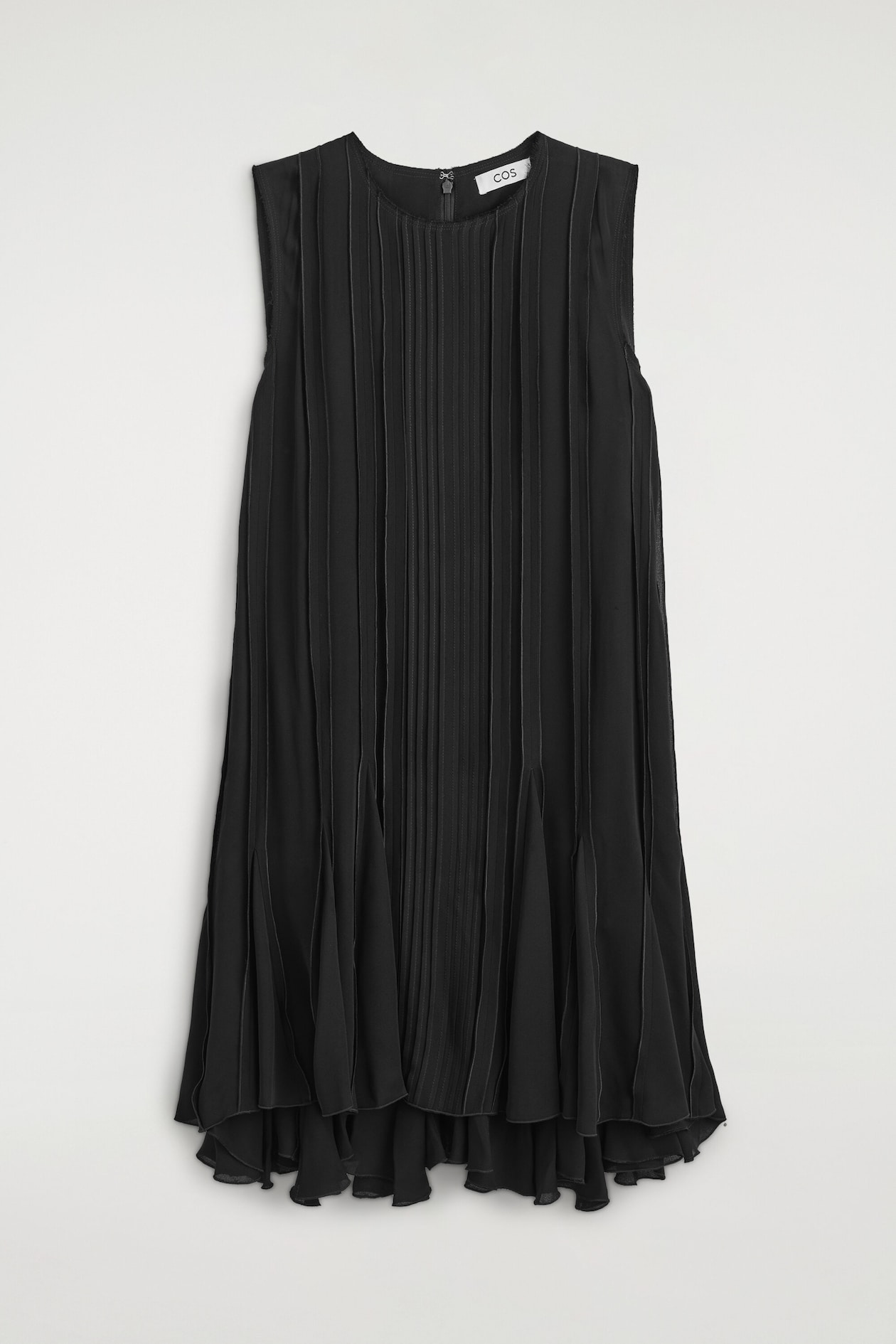 The voluminous pleated midi dress is hanging facing the front, showcasing a sleeveless design, a round neckline, and a subtle back zip fastening. Fine vertical pleats run down the body of the dress, widening towards the hem to create a flared, voluminous ruffled hemline.
