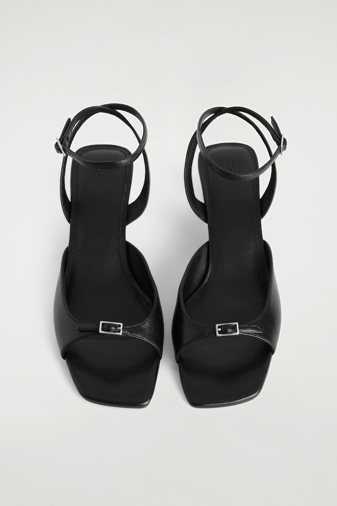 BUCKLED LEATHER KITTEN HEELS — BLACK