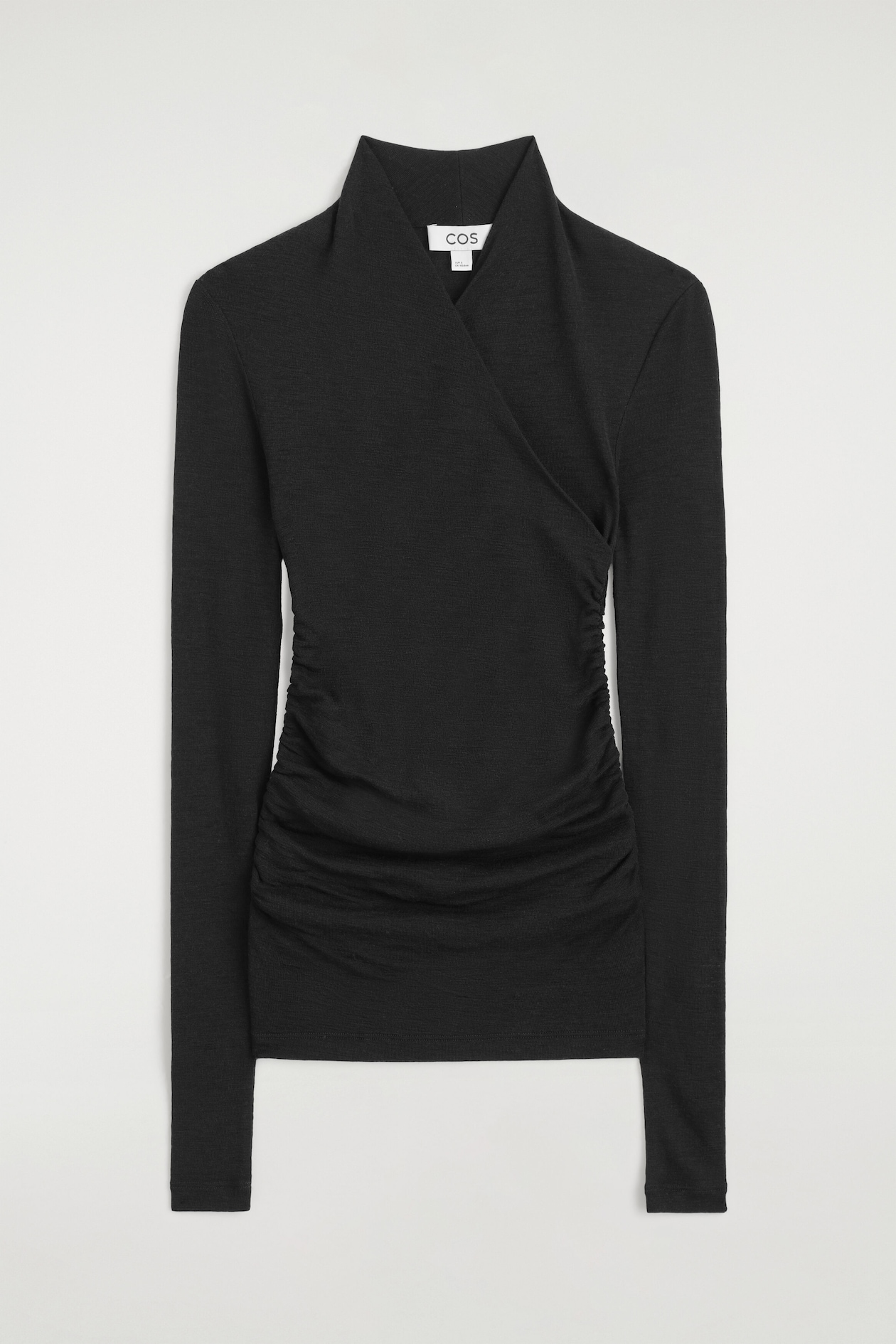 A black long-sleeve top is shown from the front, featuring a high shawl collar and an asymmetrical wrap-style front. The slim-fit garment features gathered ruching along both side seams.