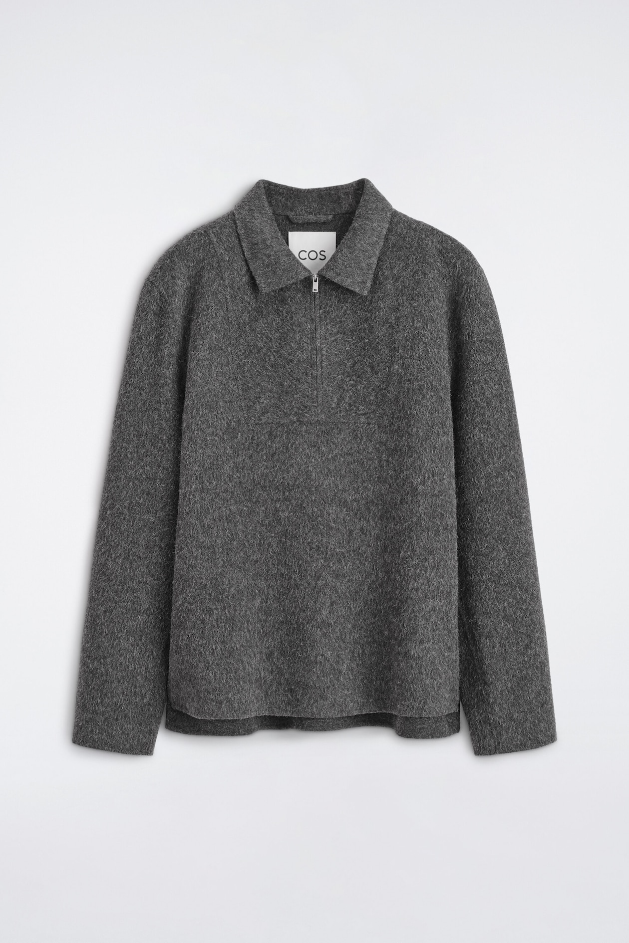 A dark gray, textured knit pullover is shown from the front, featuring a spread collar and a half-zip closure with a silver-tone zipper pull. The long-sleeve garment displays a soft, brushed finish, a relaxed fit, and a straight hem.