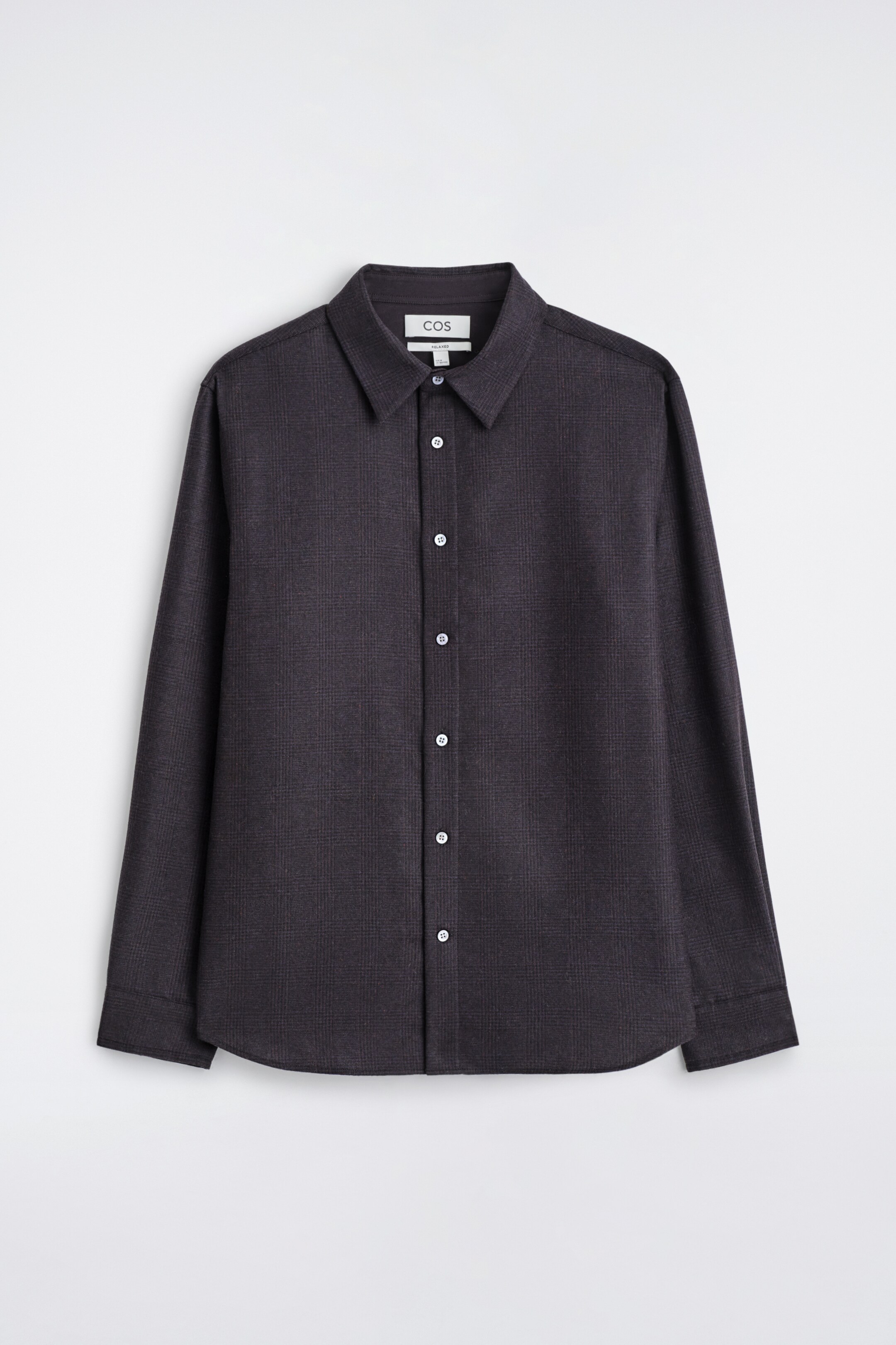 View larger image: A dark grey flannel shirt is displaying FRONT, featuring a subtle check pattern, a pointed collar, and a full button placket with light-colored buttons. It is designed with long sleeves, a relaxed fit, and a curved hem.