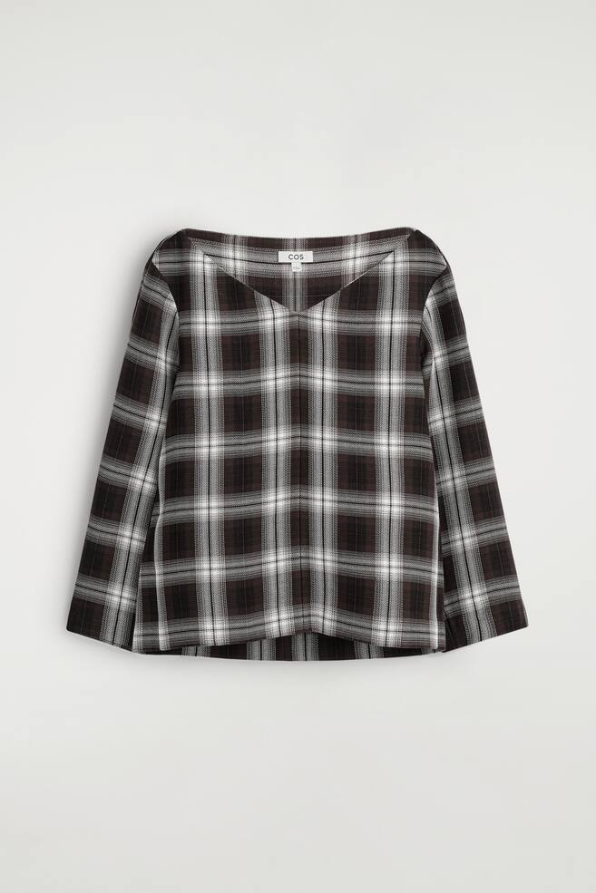 A long-sleeved top is presenting its FRONT, featuring a wide V-neckline. It is designed with a dark brown and white plaid pattern. - 1