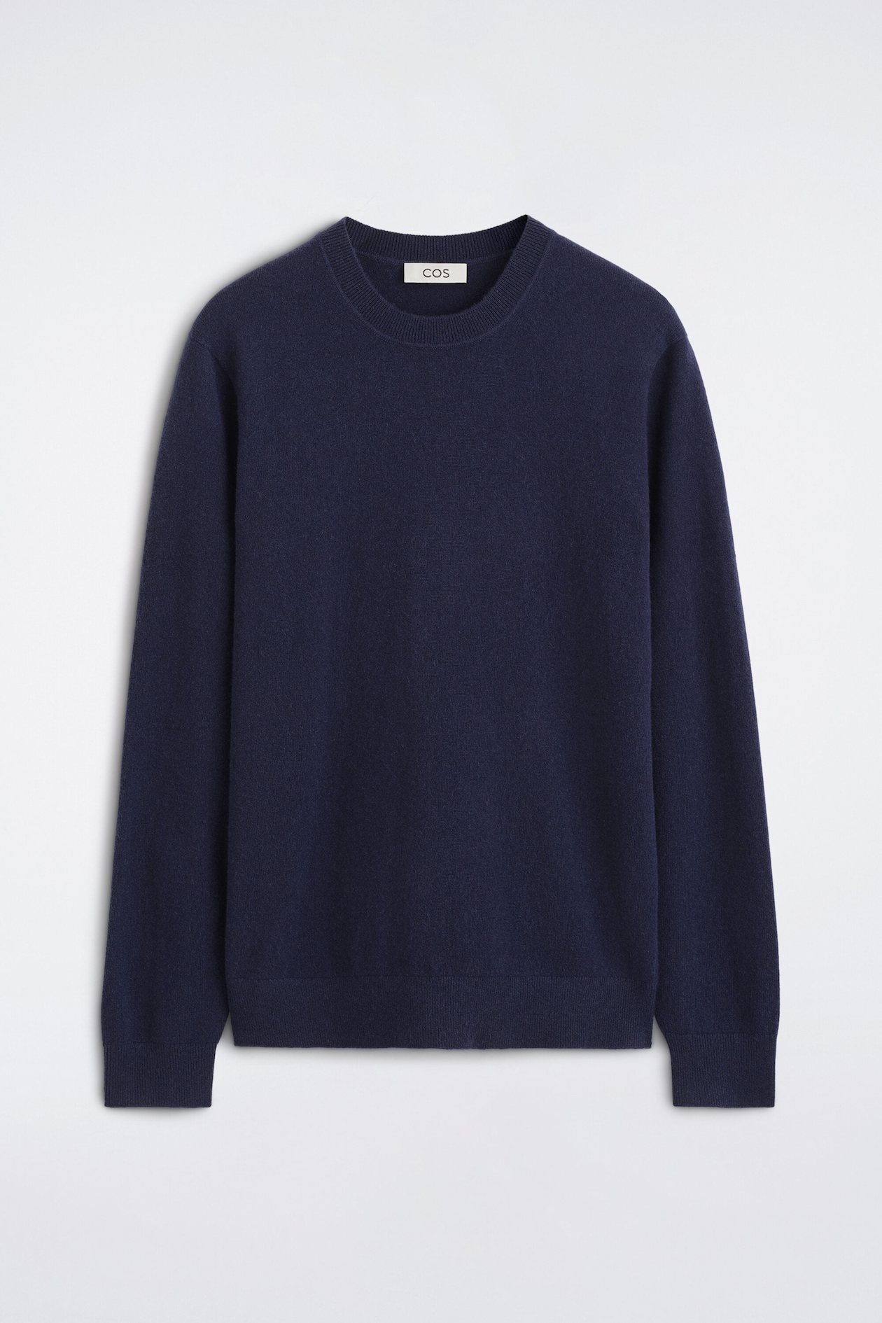 Cashmere crew-neck jumper in navy blue is shown from the front, featuring a ribbed crew neck, long sleeves with ribbed cuffs, and a matching ribbed hem.