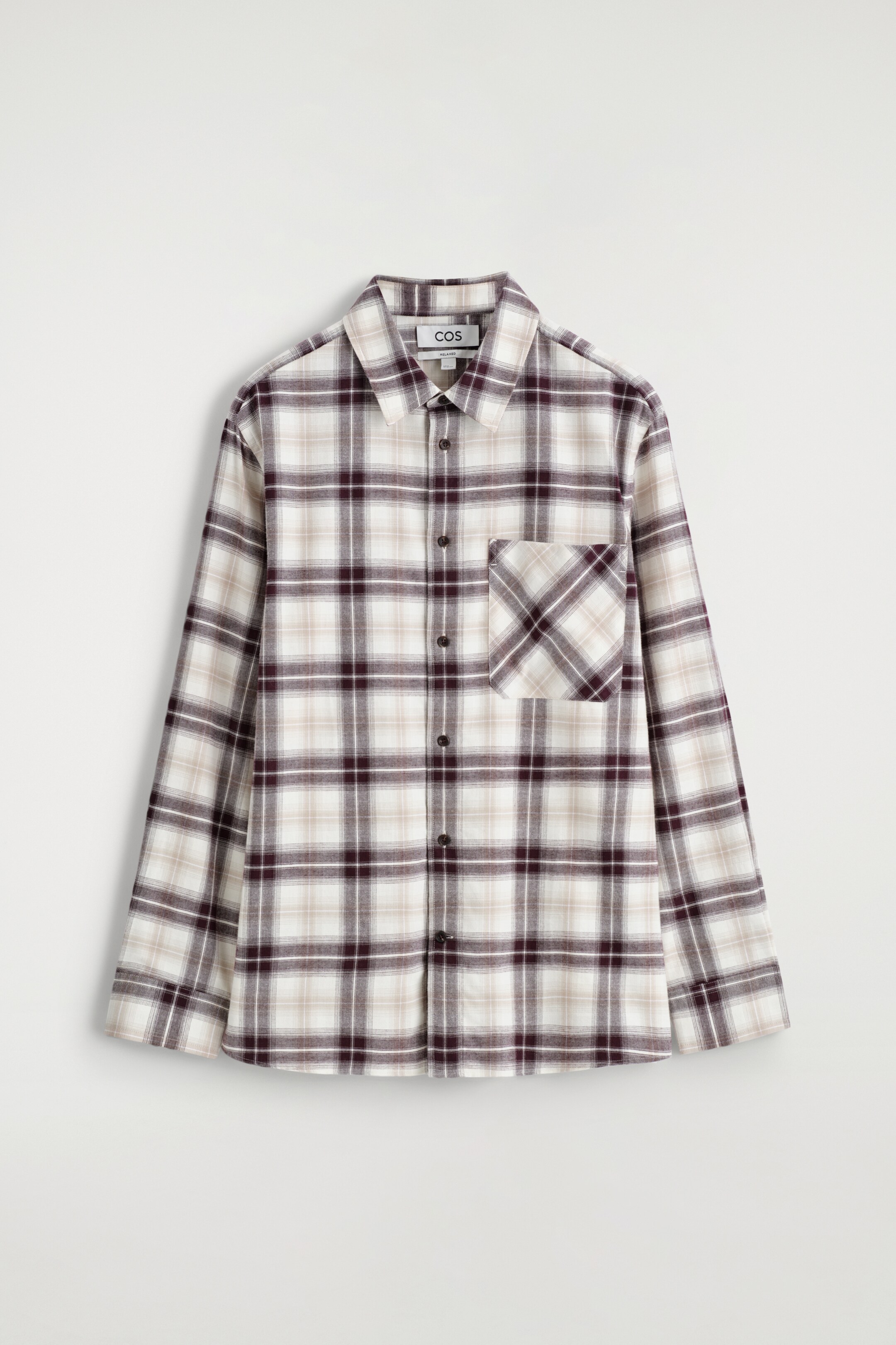 View larger image: A front view of a checked shirt is being presented, featuring an off-white base with dark brown and beige checks. It is designed with a pointed collar, a central button closure, and a single chest patch pocket.