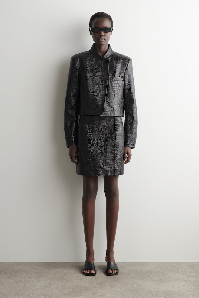 CROC-EFFECT LEATHER MINI WRAP SKIRT — BLACK