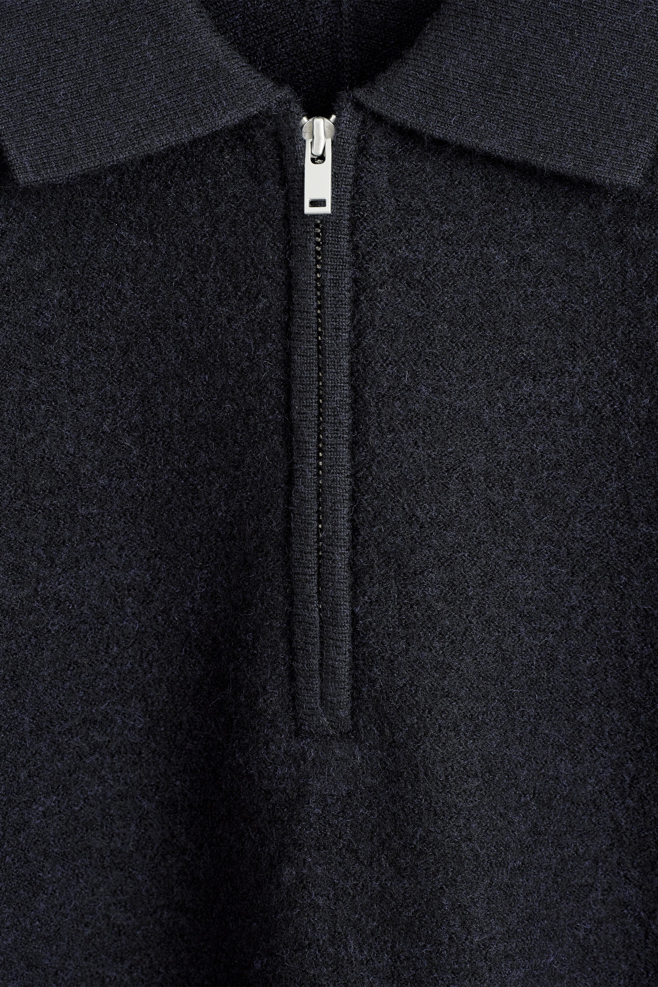 The paneled boiled-wool zip-up jumper shows a close-up of its front collar and upper chest. It features a textured dark navy boiled-wool body, a flat-knit collar, and a silver-toned half-zip closure. The paneled boiled-wool zip-up jumper shows a close-up of its front collar and upper chest. It features a textured dark navy boiled-wool body, a flat-knit collar, and a silver-toned half-zip closure.