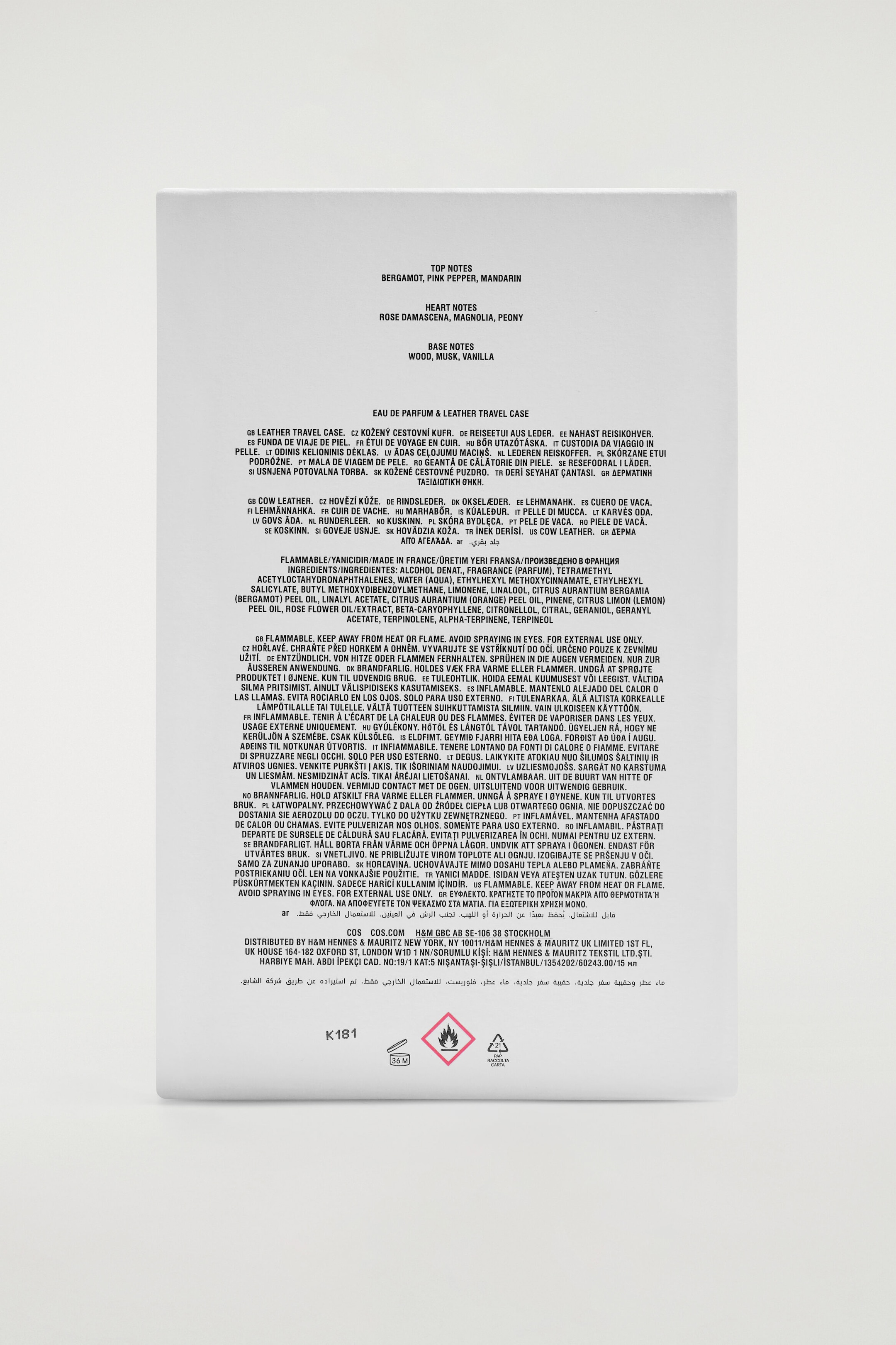 A rectangular white cardboard box is showing its back panel, which features detailed black printed text. The text lists the top, heart, and base fragrance notes at the top, followed by ingredients, multilingual safety warnings, and distributor information, with safety and recycling symbols positioned at the very bottom. A rectangular white cardboard box is showing its back panel, which features detailed black printed text. The text lists the top, heart, and base fragrance notes at the top, followed by ingredients, multilingual safety warnings, and distributor information, with safety and recycling symbols positioned at the very bottom.