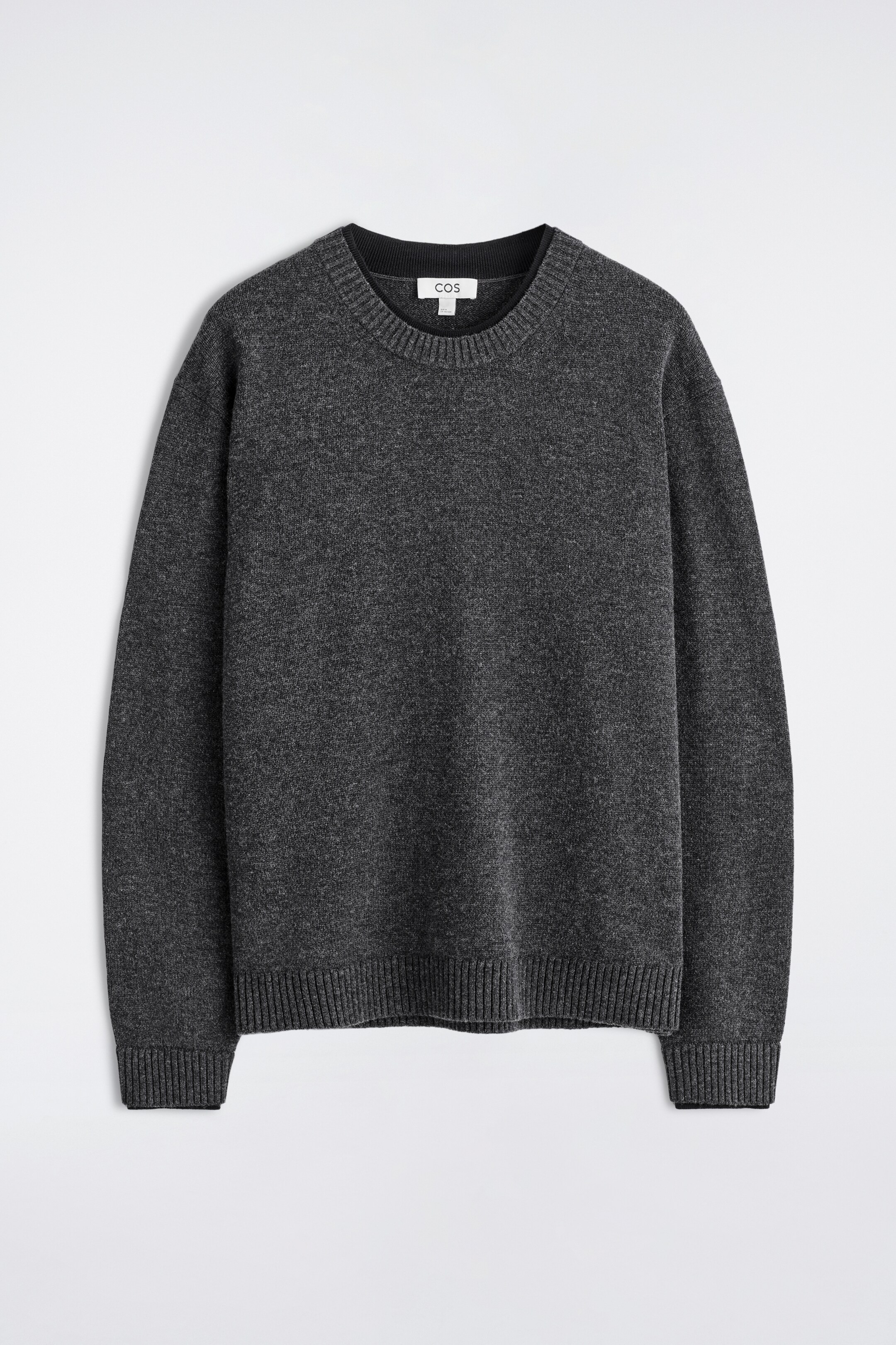 View larger image: A charcoal grey merino wool crew neck sweater is presented in a front view. It is featuring a ribbed crew neckline, ribbed cuffs, and a ribbed hem, with the neckline and cuffs displaying a subtle dark, double-edged finish.